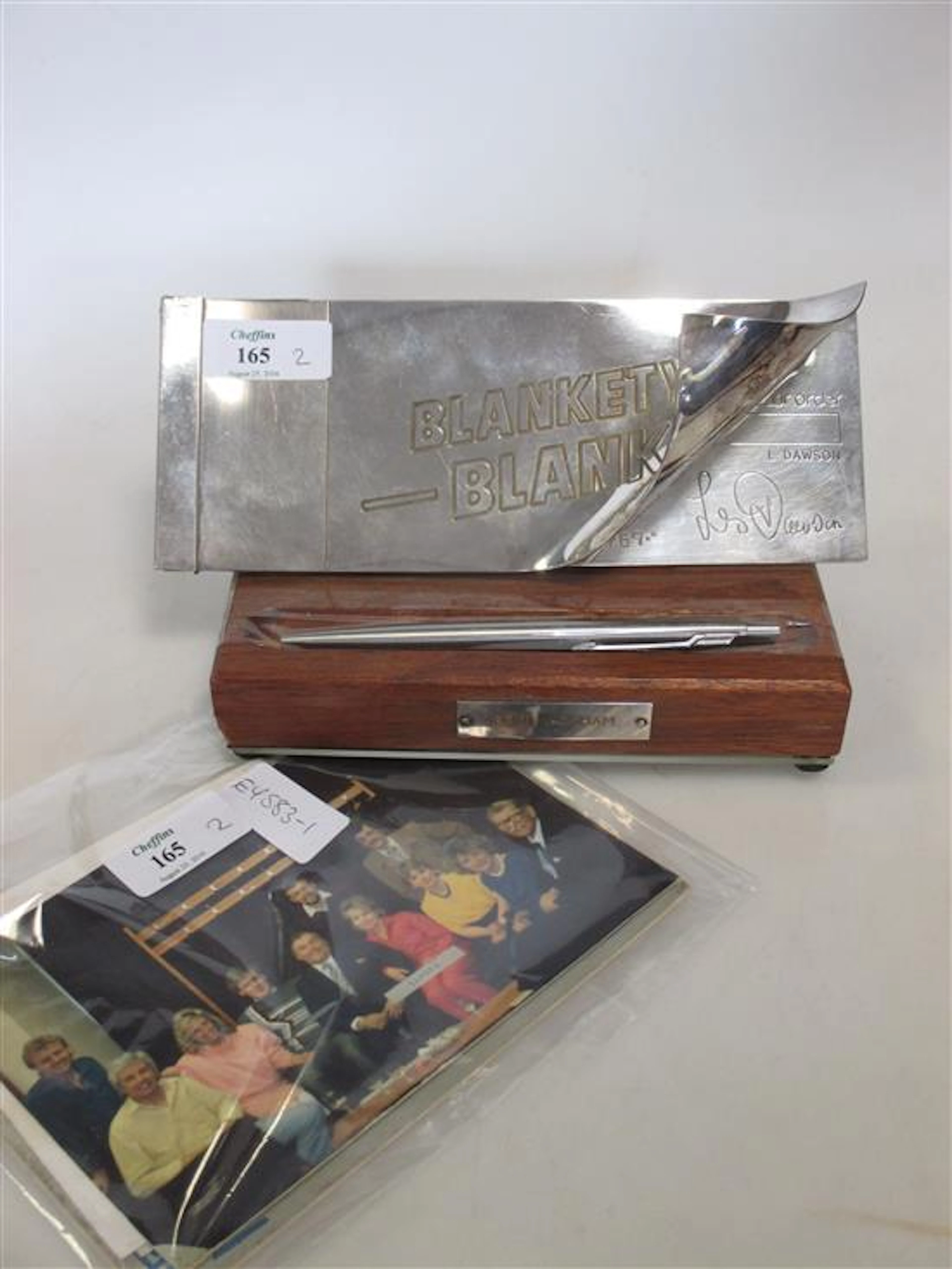 A Blankety Blank cheque book and pen, signed to the base by Les Dawson