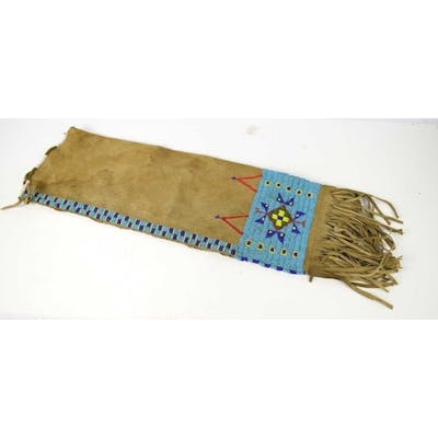 A Native American tanned hide and beaded pipe bag, the bag d... | Barnebys