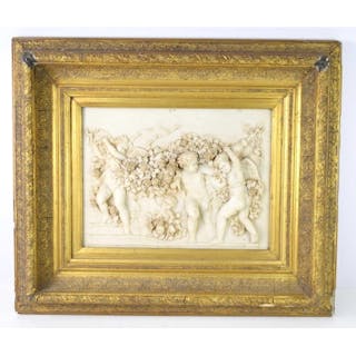 A resin wall plaque in high relief depicting putti, set with...