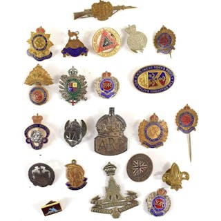 A group of badges and brooches to include a Essex Regiment s...