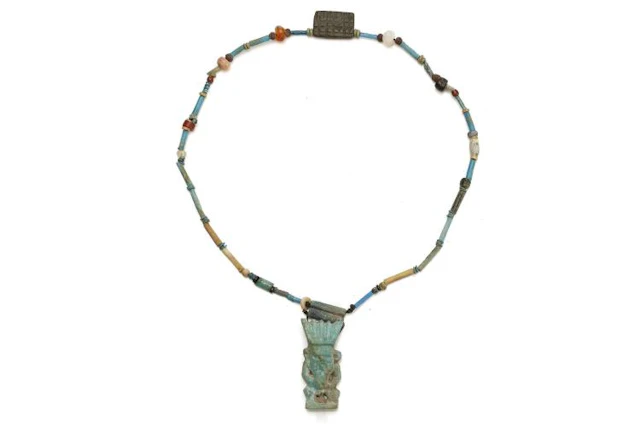 AN EGYPTIAN GLAZED COMPOSITION BES AMULET NECKLACE Late Period