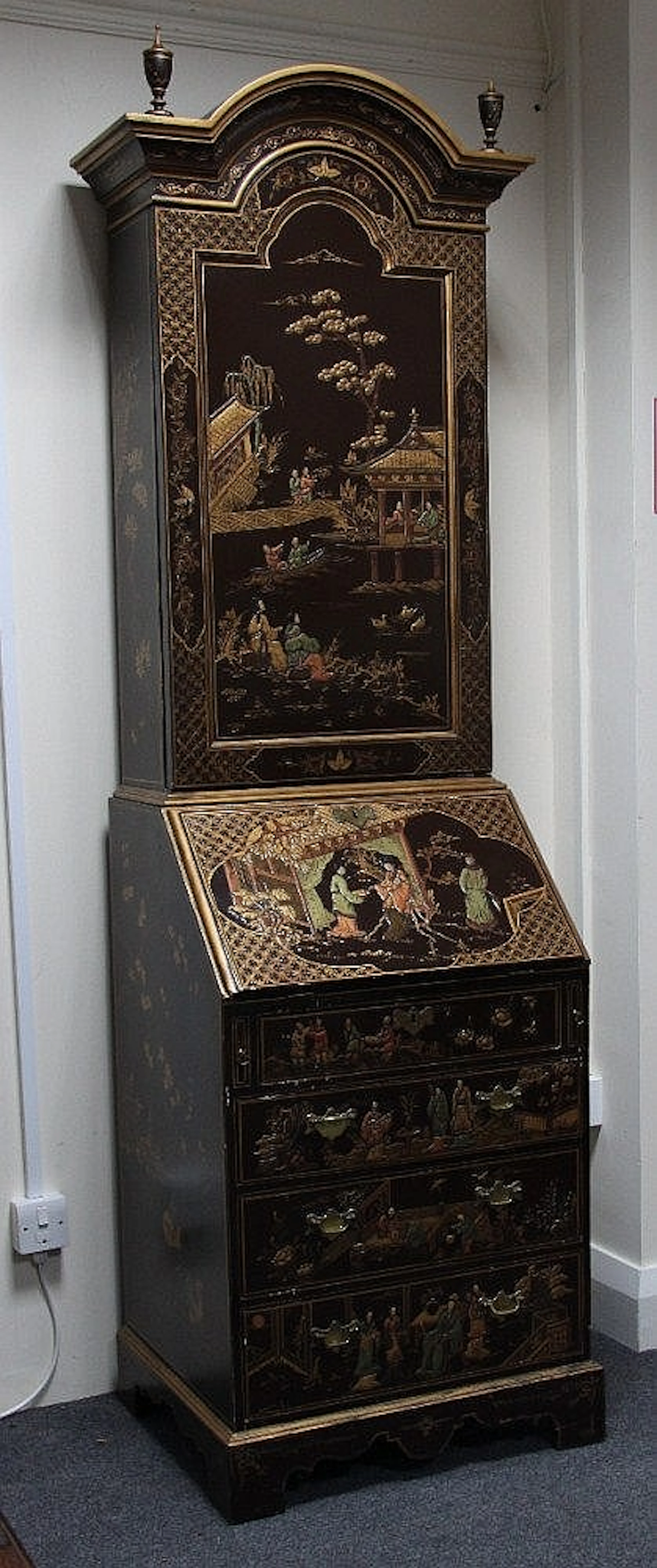 A narrow bureau bookcase, lacquered with Oriental
