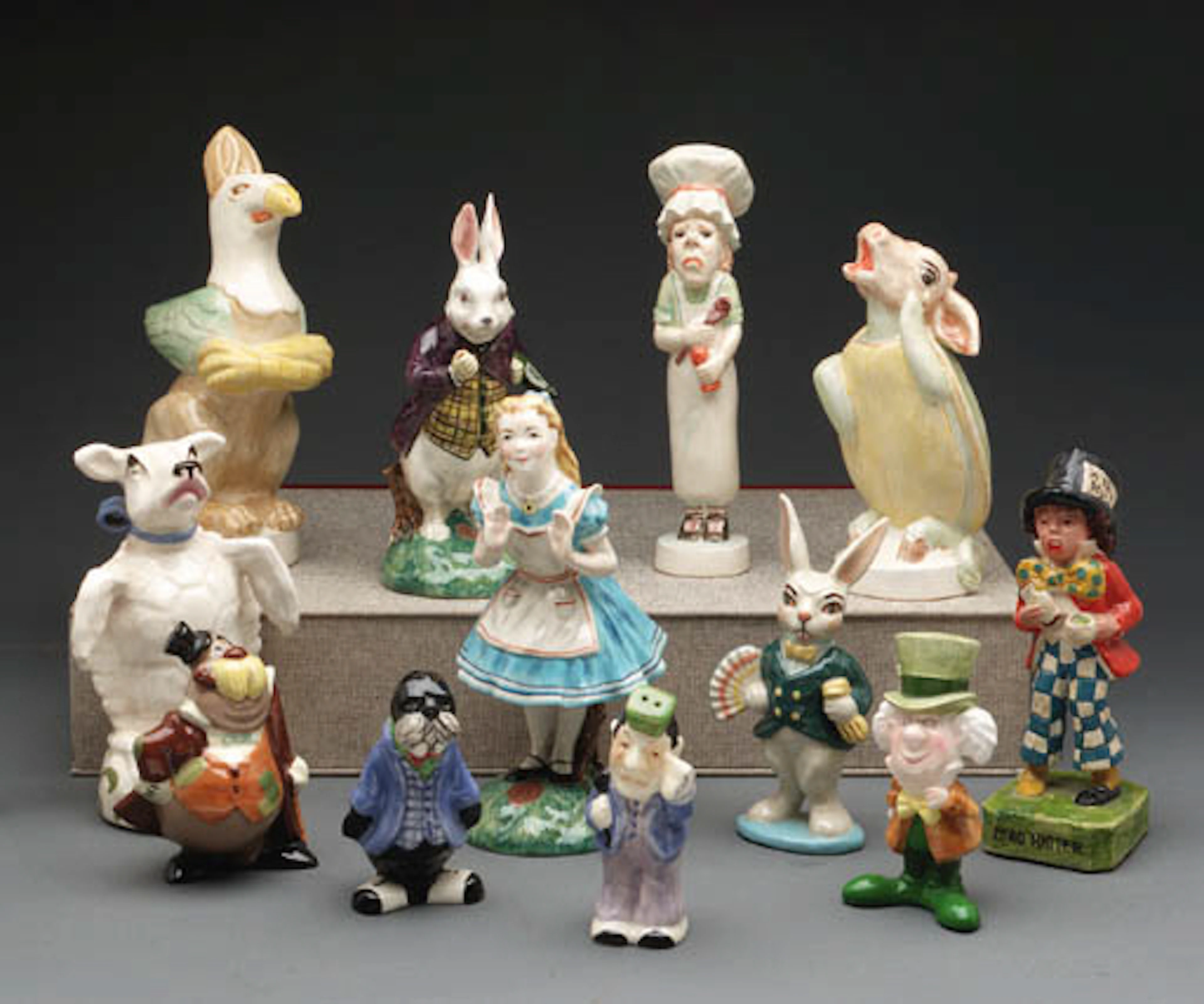 [PORCELAIN FIGURES, ETC.]. 12 hand-painted figures (11 ceramic and one plaster) of characters from Alice's Adventures in Wonderland and Through the Looking-Glass. 1940s-70s. Various sizes (from 100mm.
