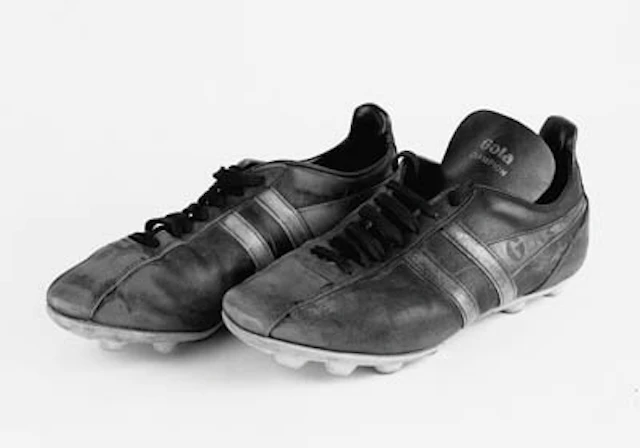 A pair of black with yellow flashes Gola football boots, size 8, each inscribed W S; a colour poster of Liverpool F.C., 1973, depicting Bill Shankly wearing the