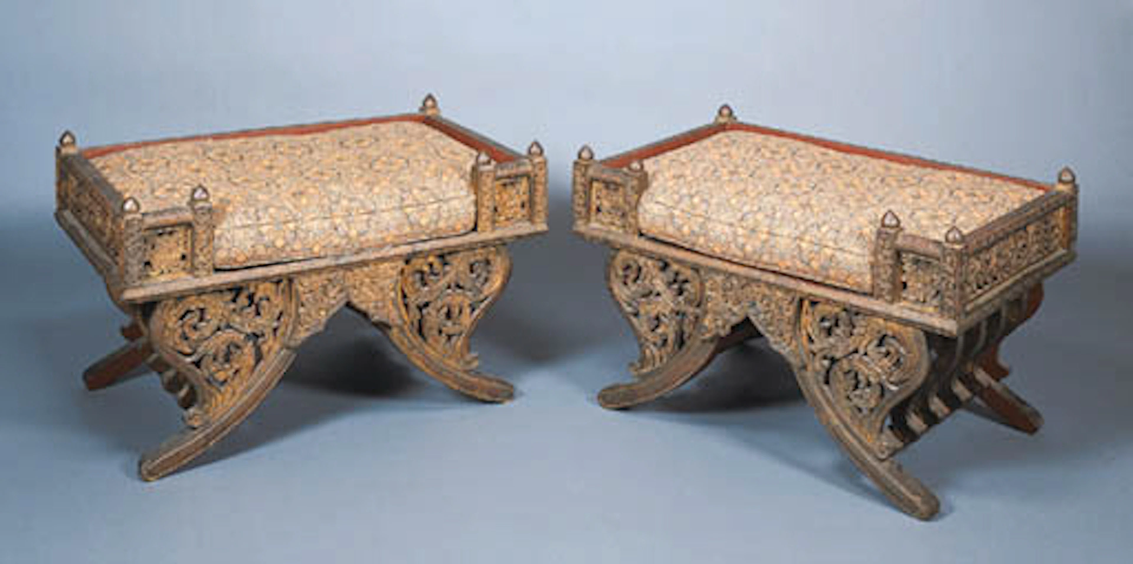 A PAIR OF SOUTH-EAST ASIAN CARVED EXOTIC WOOD BENCHES