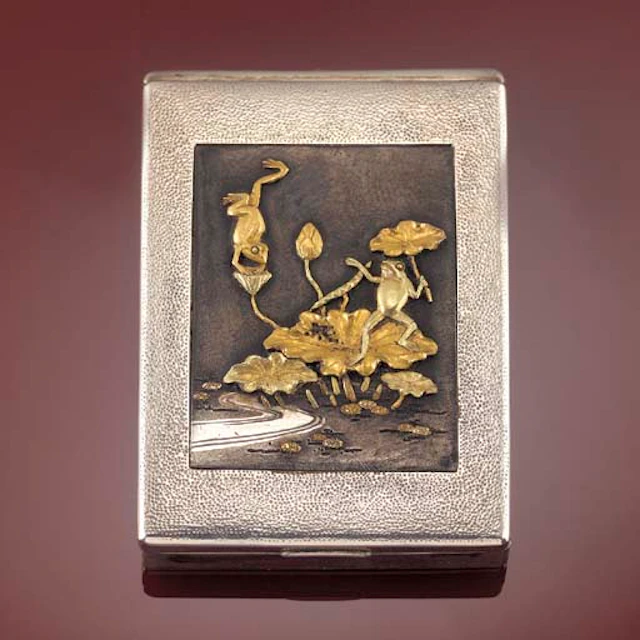 A silvered metal stamp case