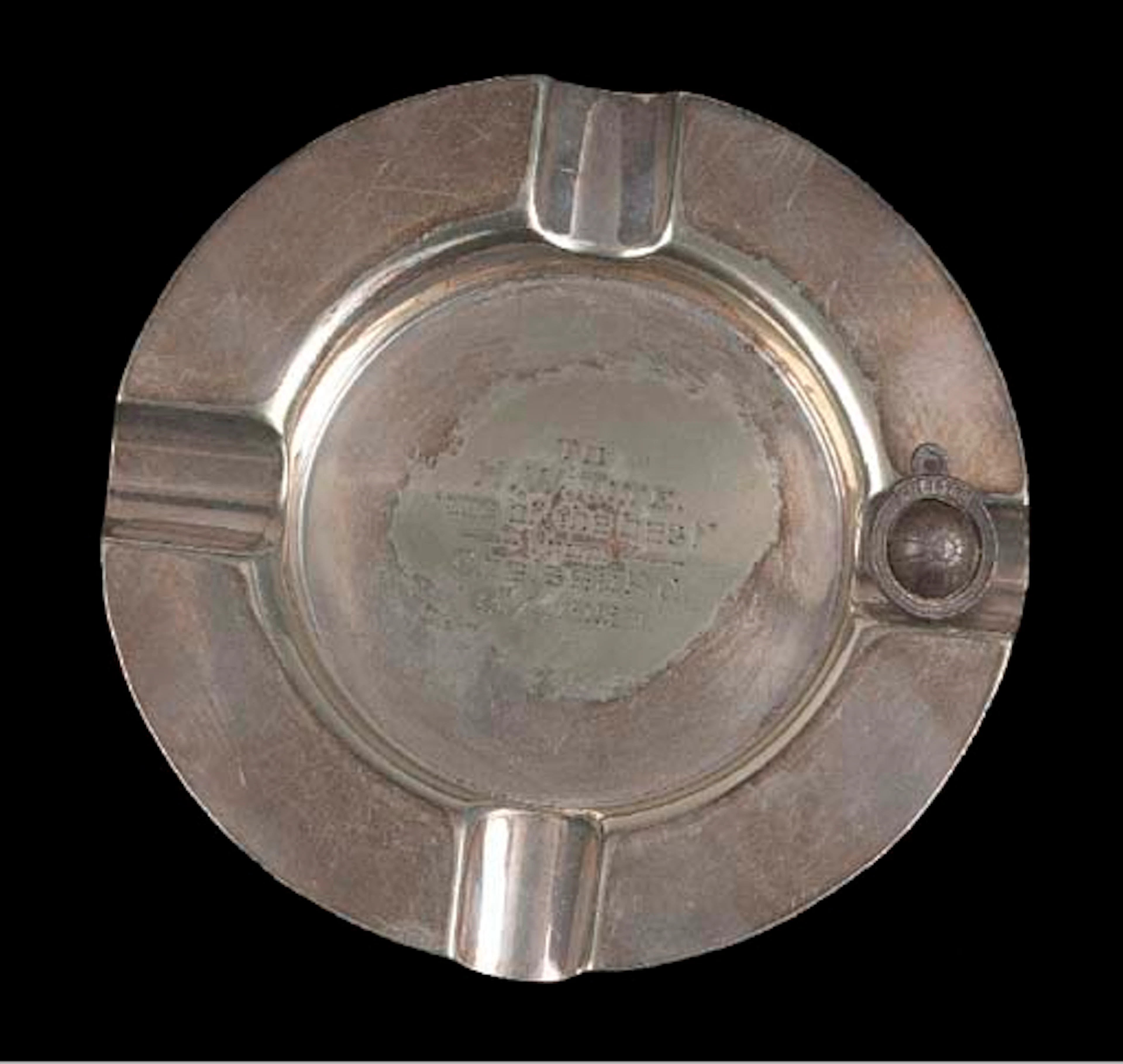 A white-metal ashtray, inscribed To H. W. Tite., "one of the best", from Chelsea F.C., B.A., 1929, 5½in. (14cm) wide; and a white-metal fob watch chain spinner, modelled