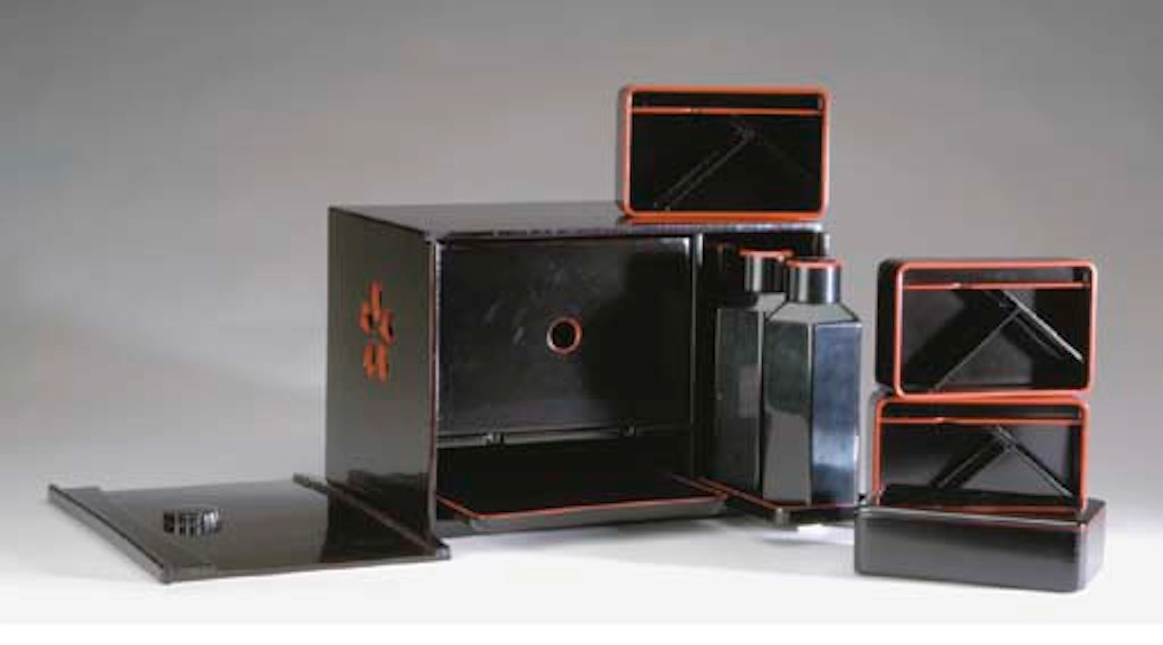 A JAPANESE RED AND BLACK LACQUER PICNIC BOX