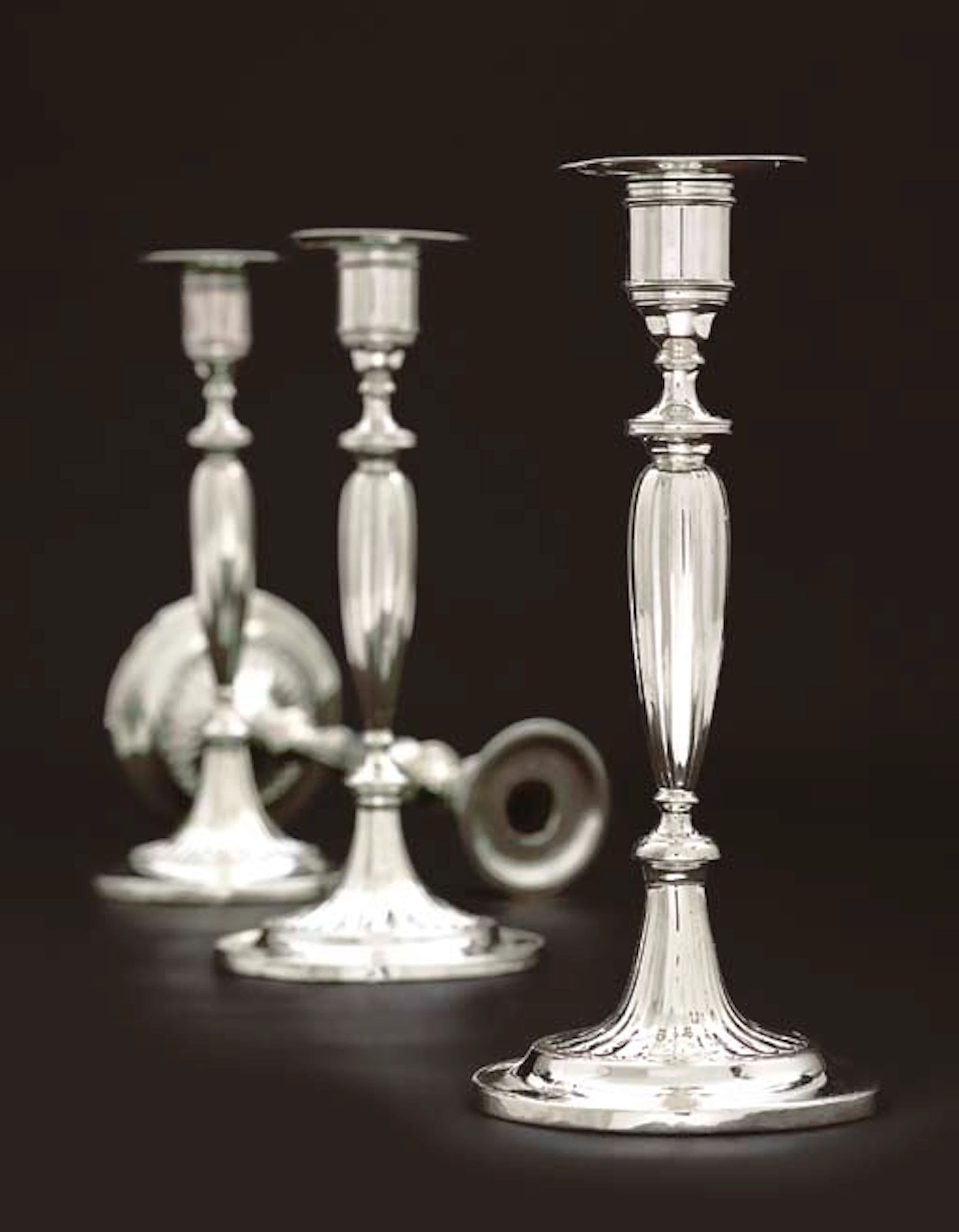A SET OF FOUR AUSTRIAN SILVER CANDLESTICKS