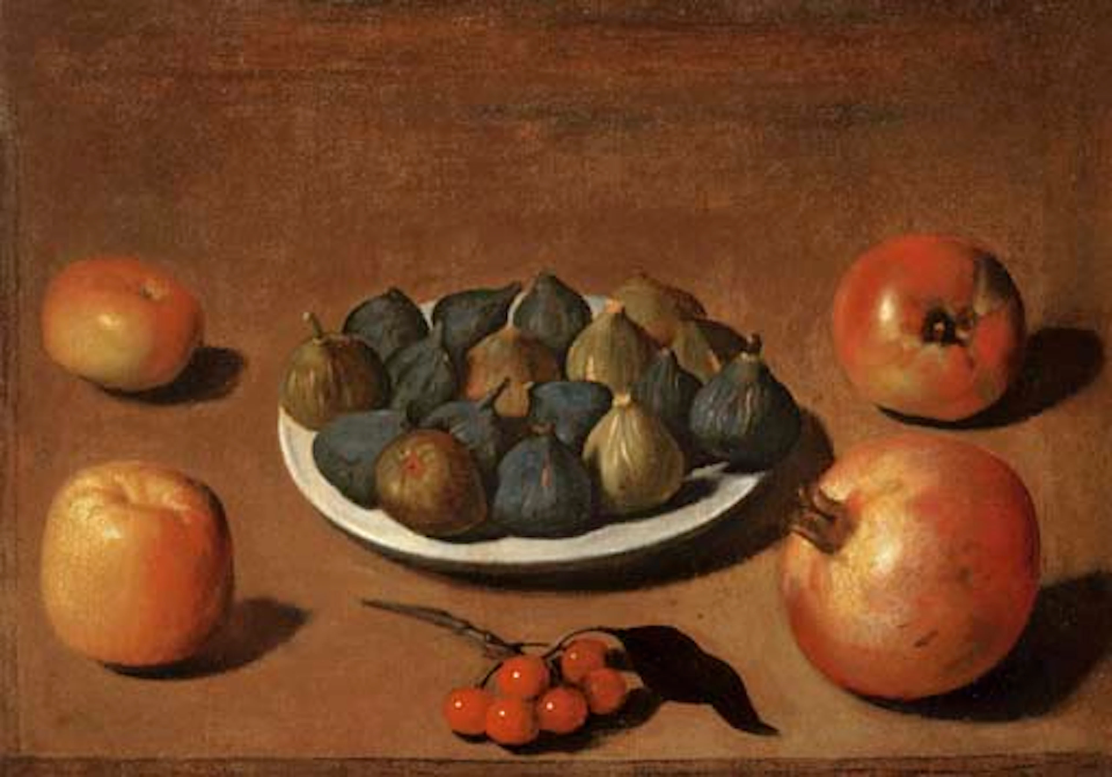 Plate of figs with apples, cherries and a pomegranate