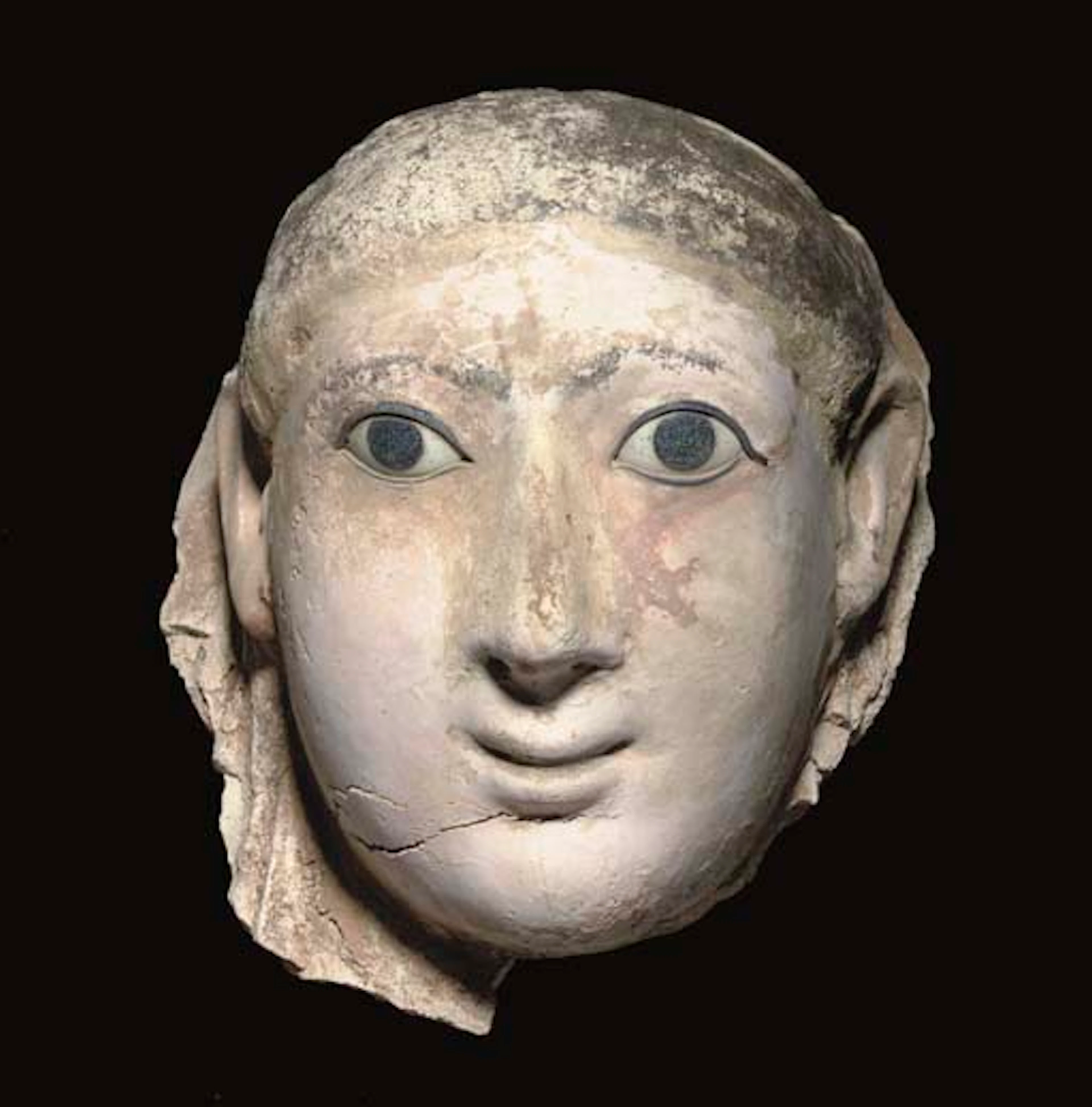 AN EGYPTIAN PAINTED STUCCO PORTRAIT MASK OF A YOUTH