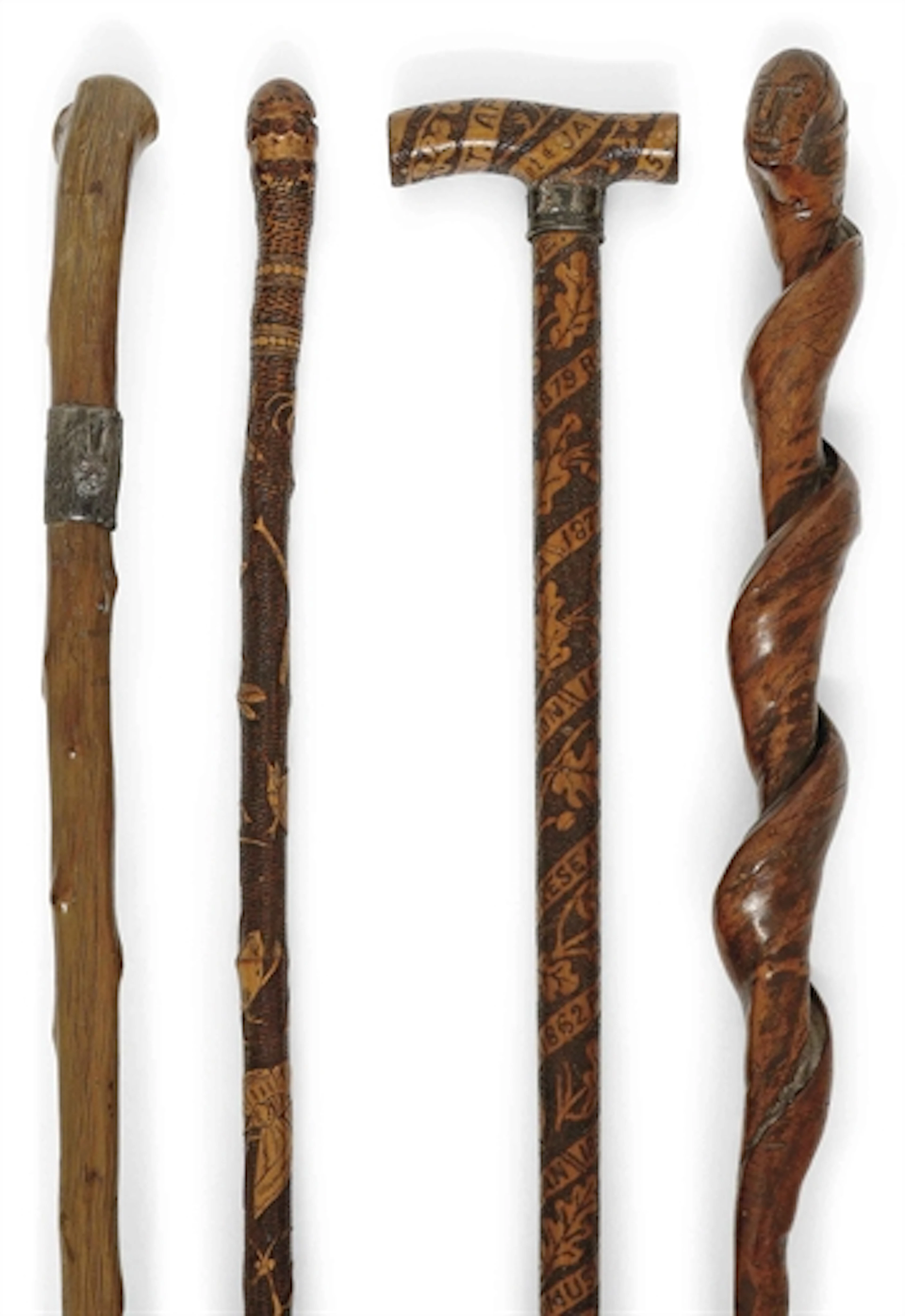 FOUR BRITISH CARVED-WOOD WALKING STICKS