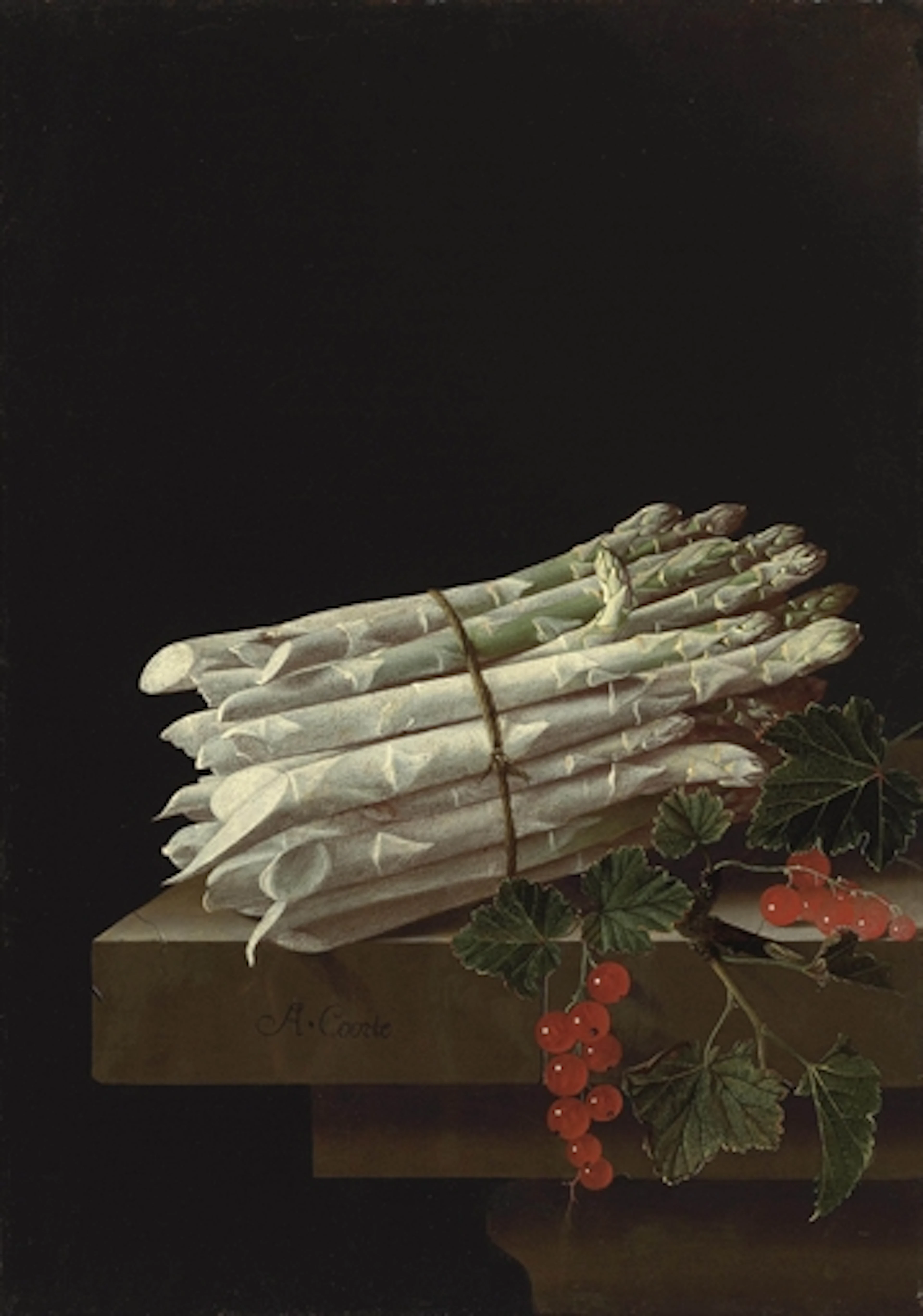 Asparagus and red currants on a stone ledge