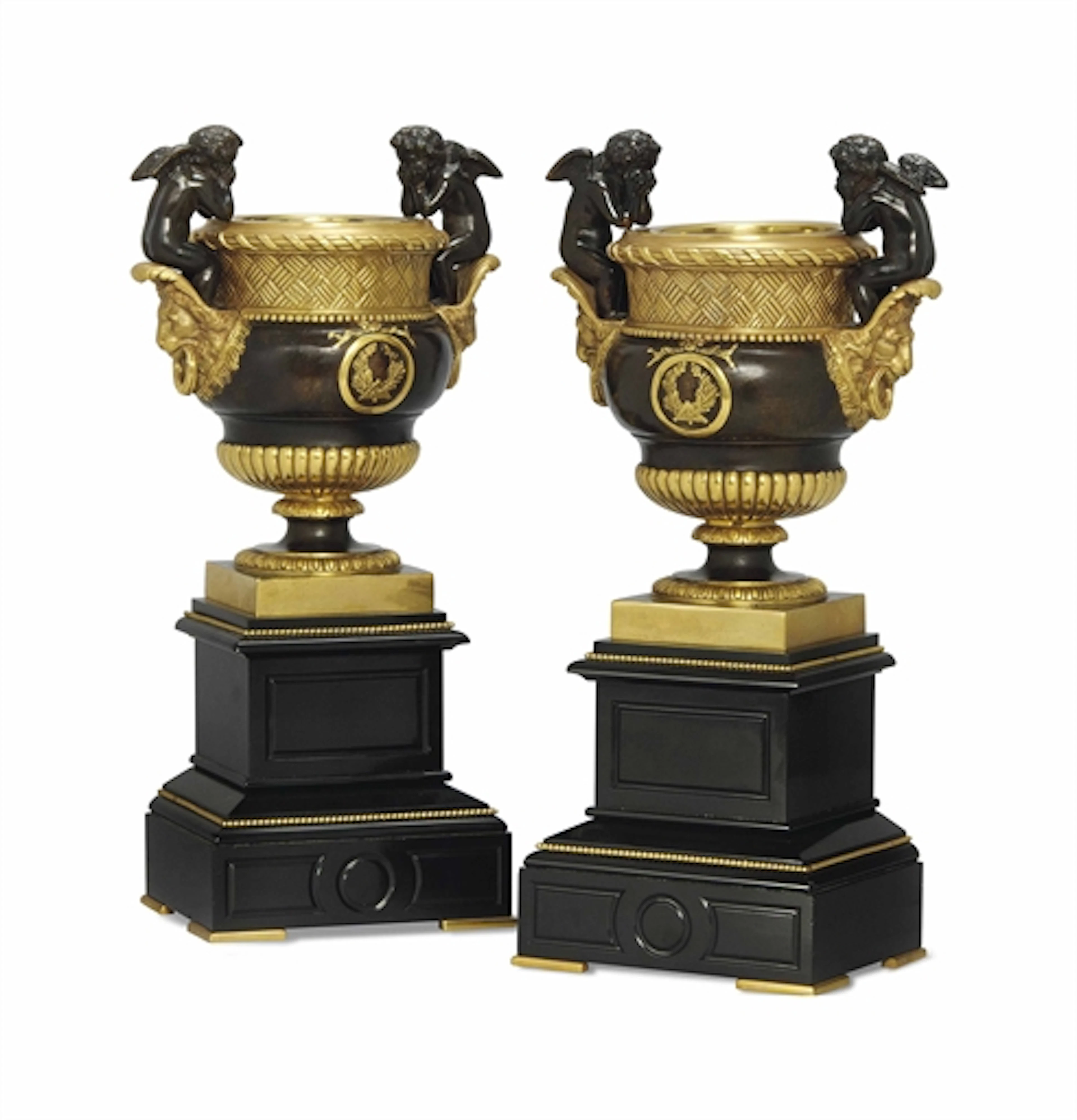 A PAIR OF GILT AND PATINATED BRONZE URNS