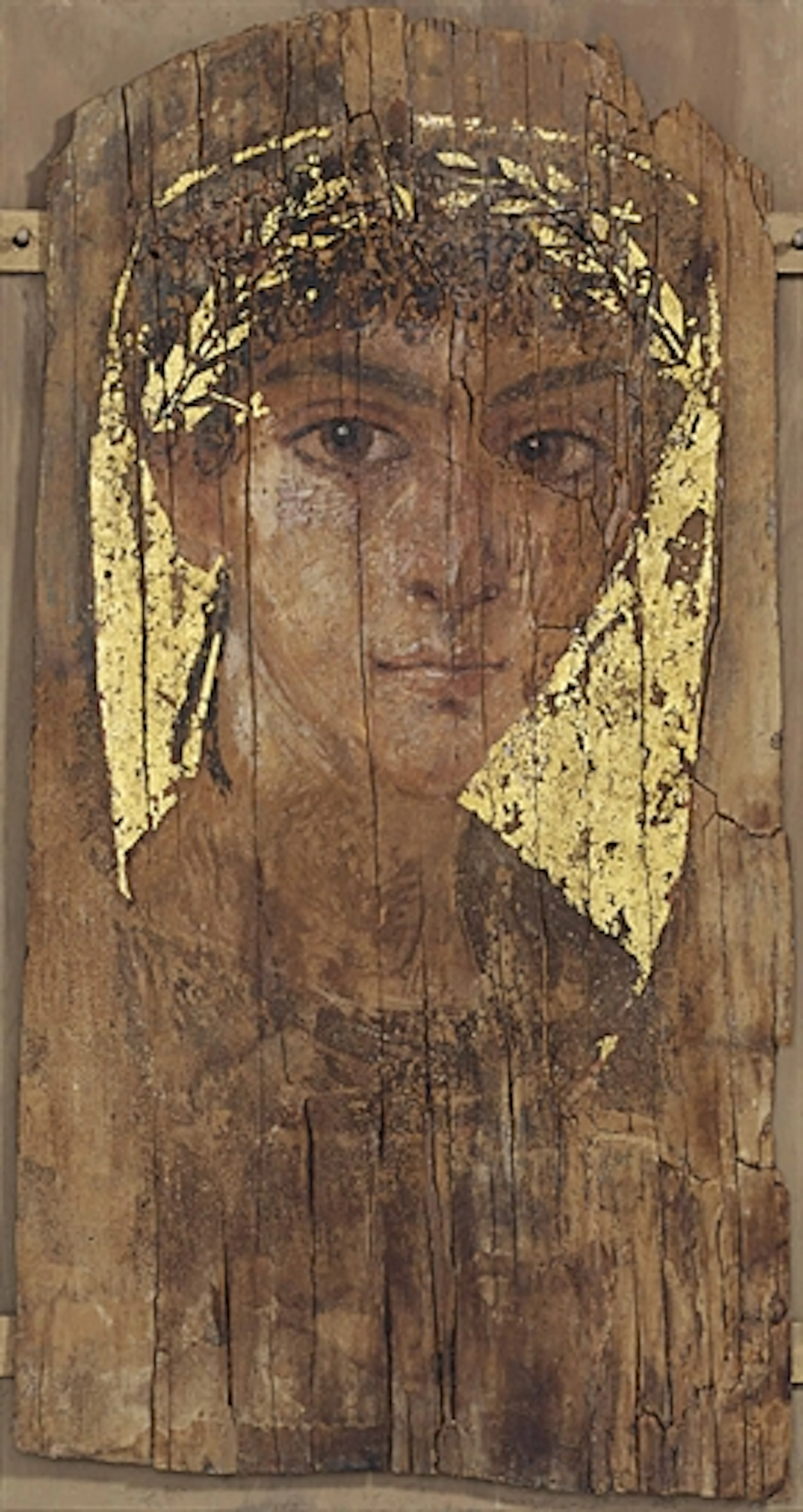 AN EGYPTIAN PAINTED WOOD MUMMY PORTRAIT OF