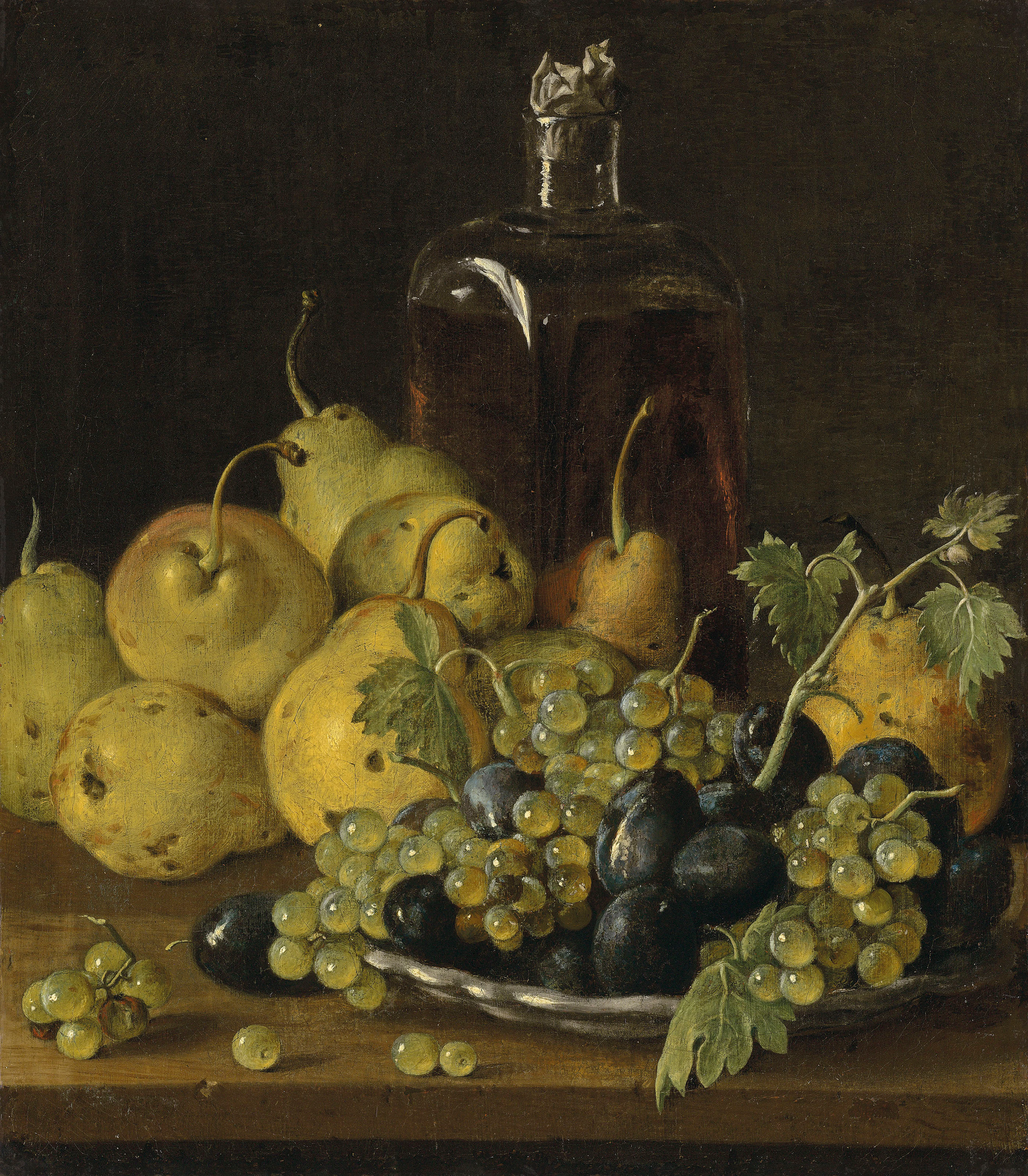 Grapes and plums on a plate, with pears and a glass bottle on a wooden ledge
