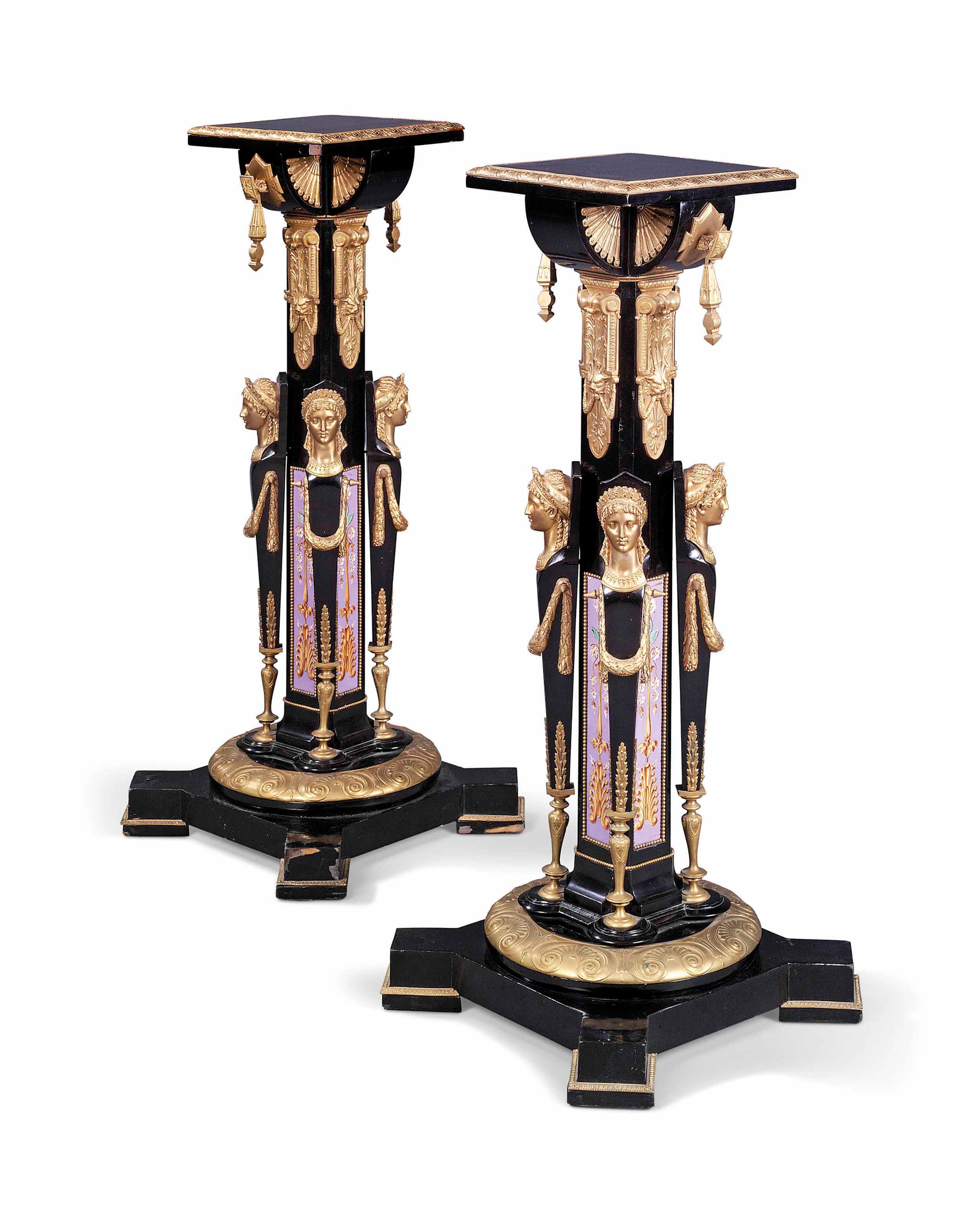 A pair of french gilt-copper and ceramic-mounted ebony and ebonized pedestals