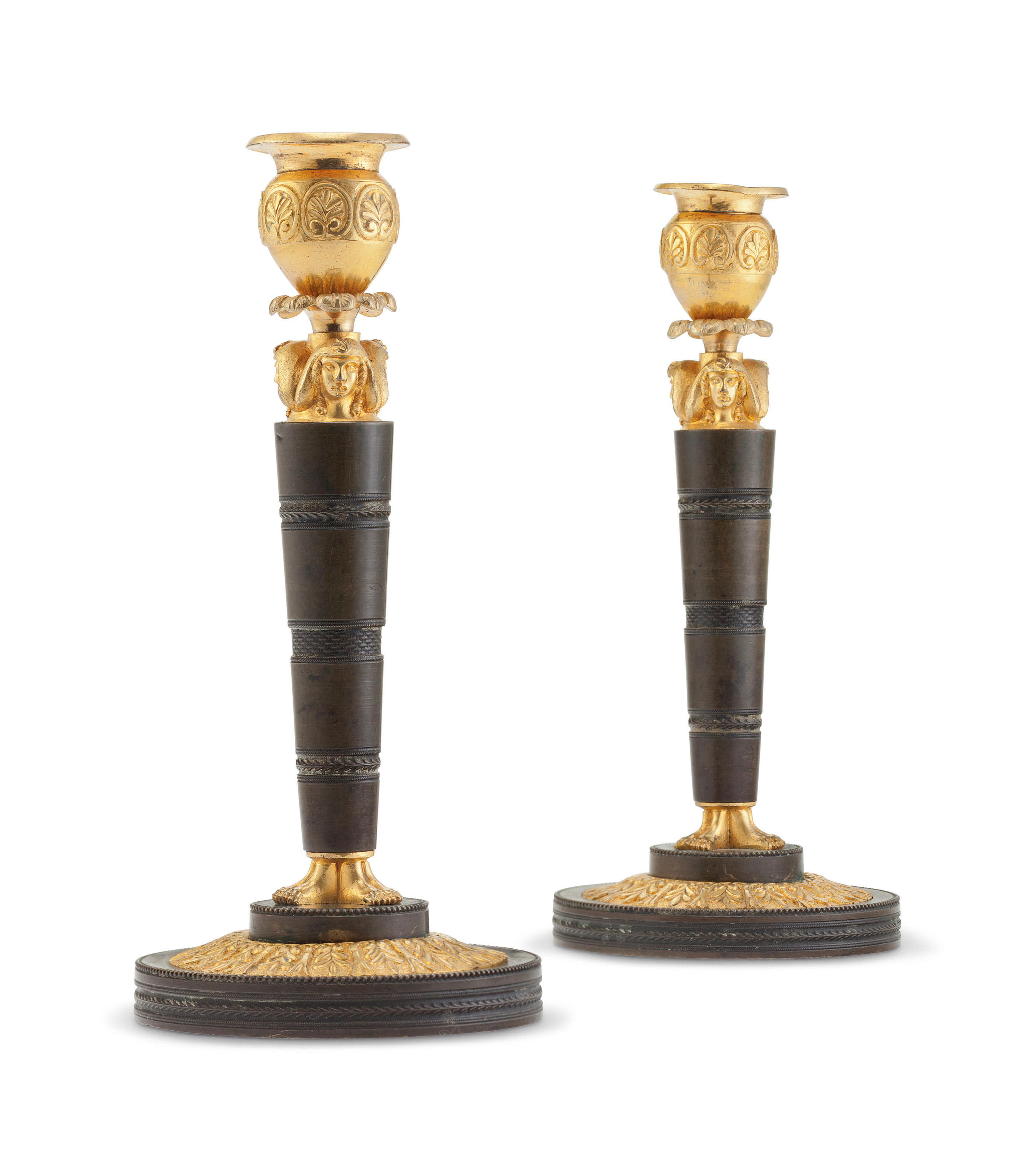 A PAIR OF RUSSIAN ORMOLU AND PATINATED BRONZE CANDLESTICKS AFTER A