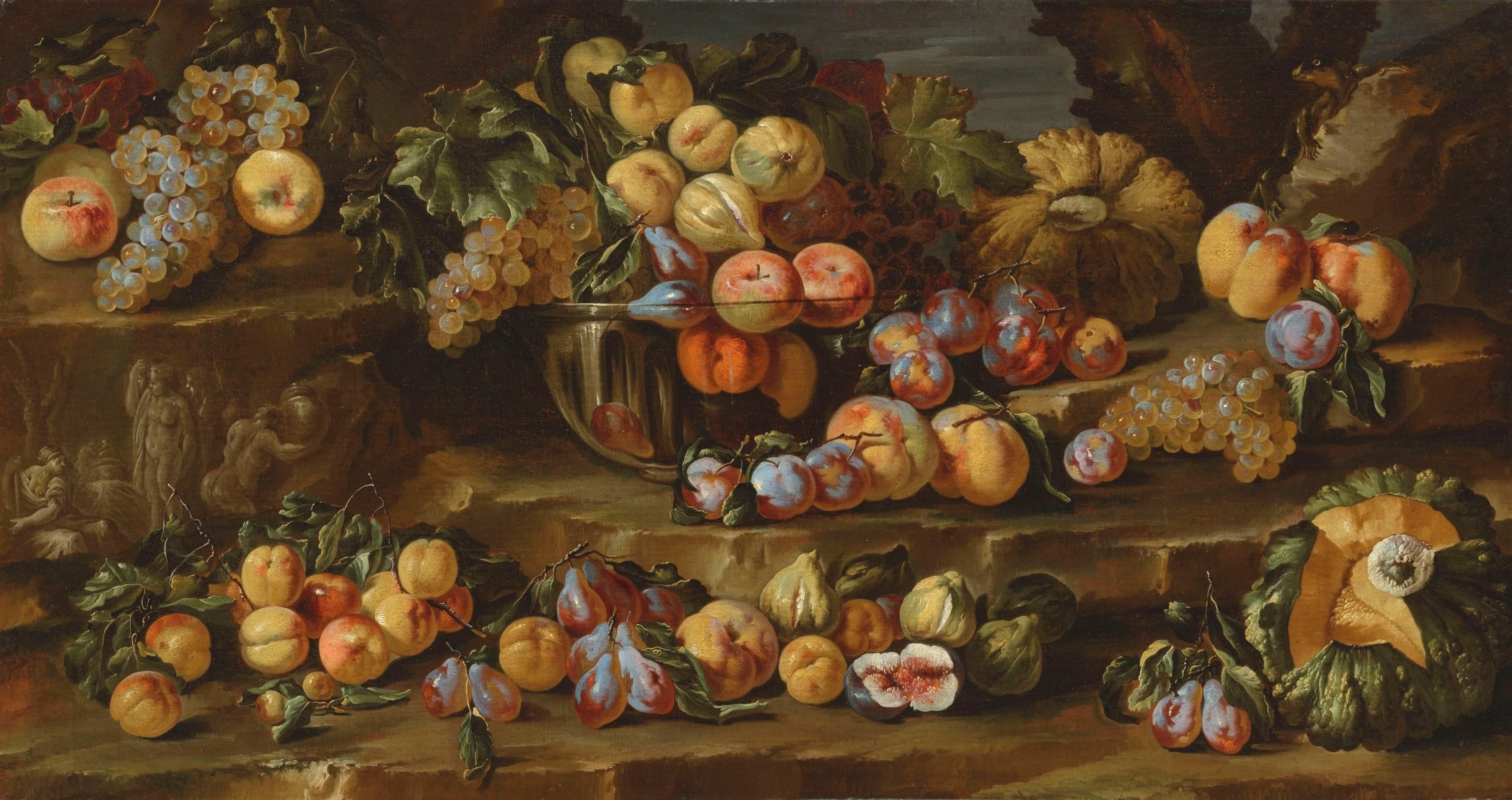 Plums, grapes, apples and other fruit in a glass bowl and scattered on a ledge