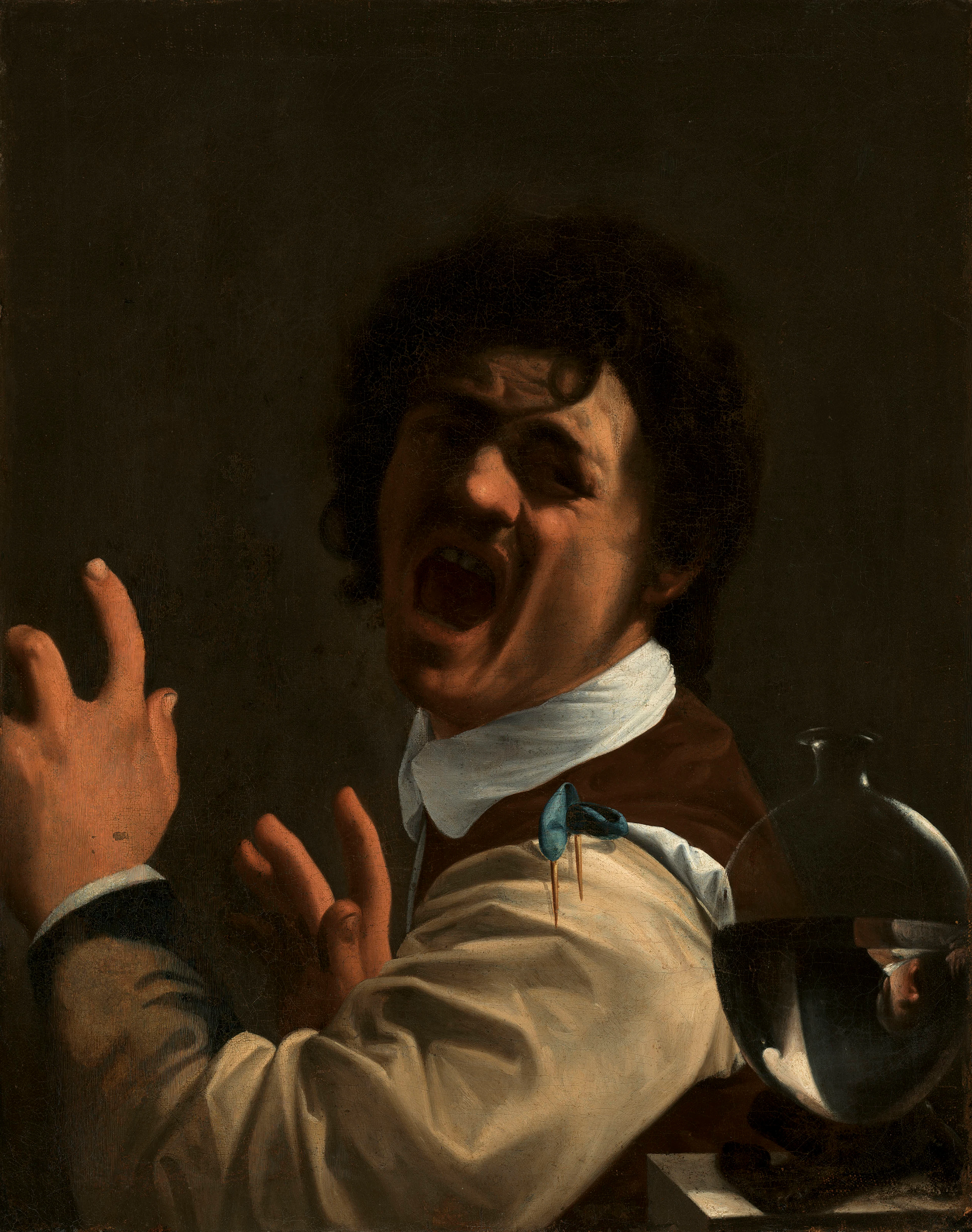 A seated man recoiling