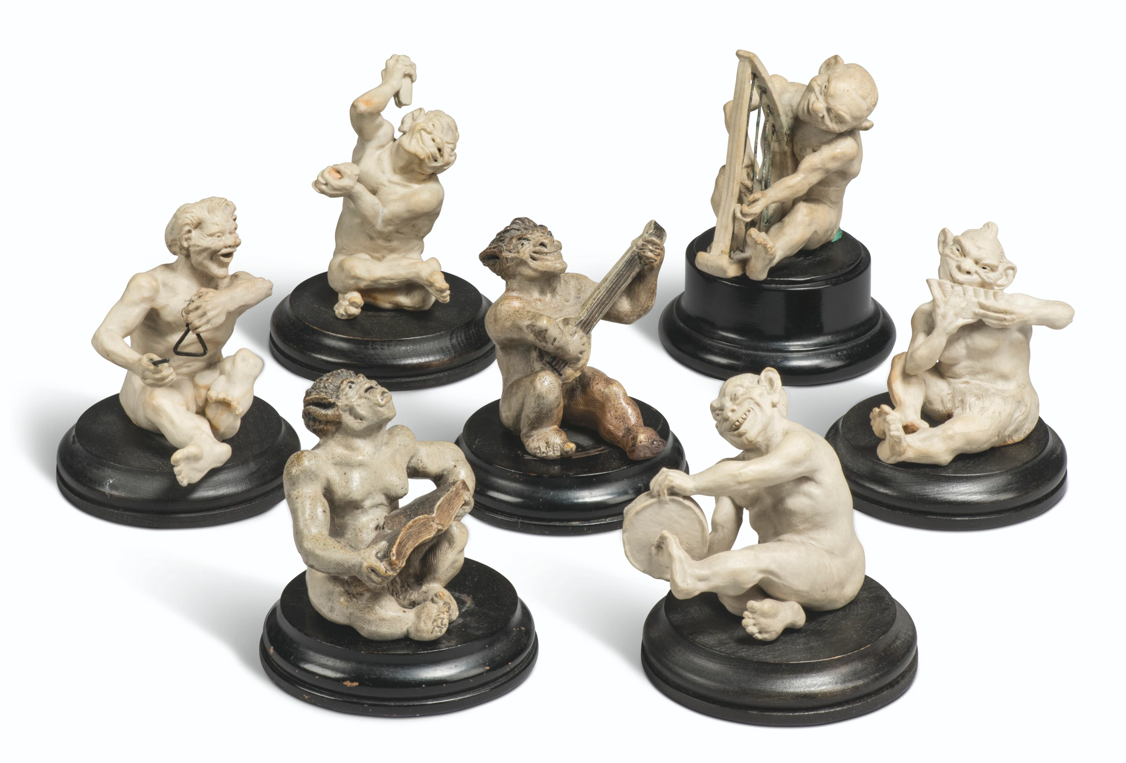 A GROUP OF SEVEN MARTIN BROTHERS STONEWARE MUSICAL IMPS BY ROBERT WALLACE MARTIN