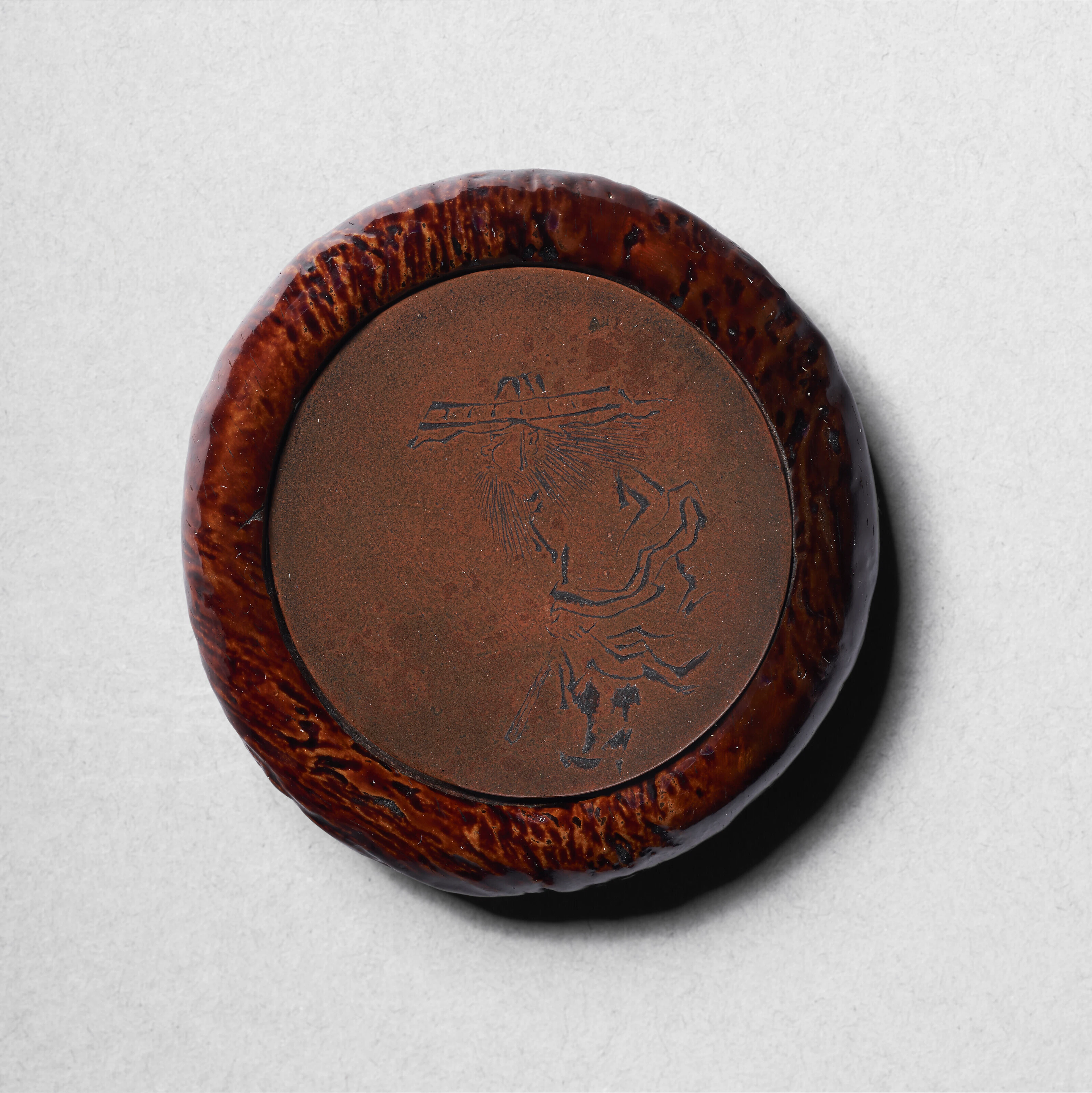 A RARE LACQUER KAGAMIBUTA NETSUKE