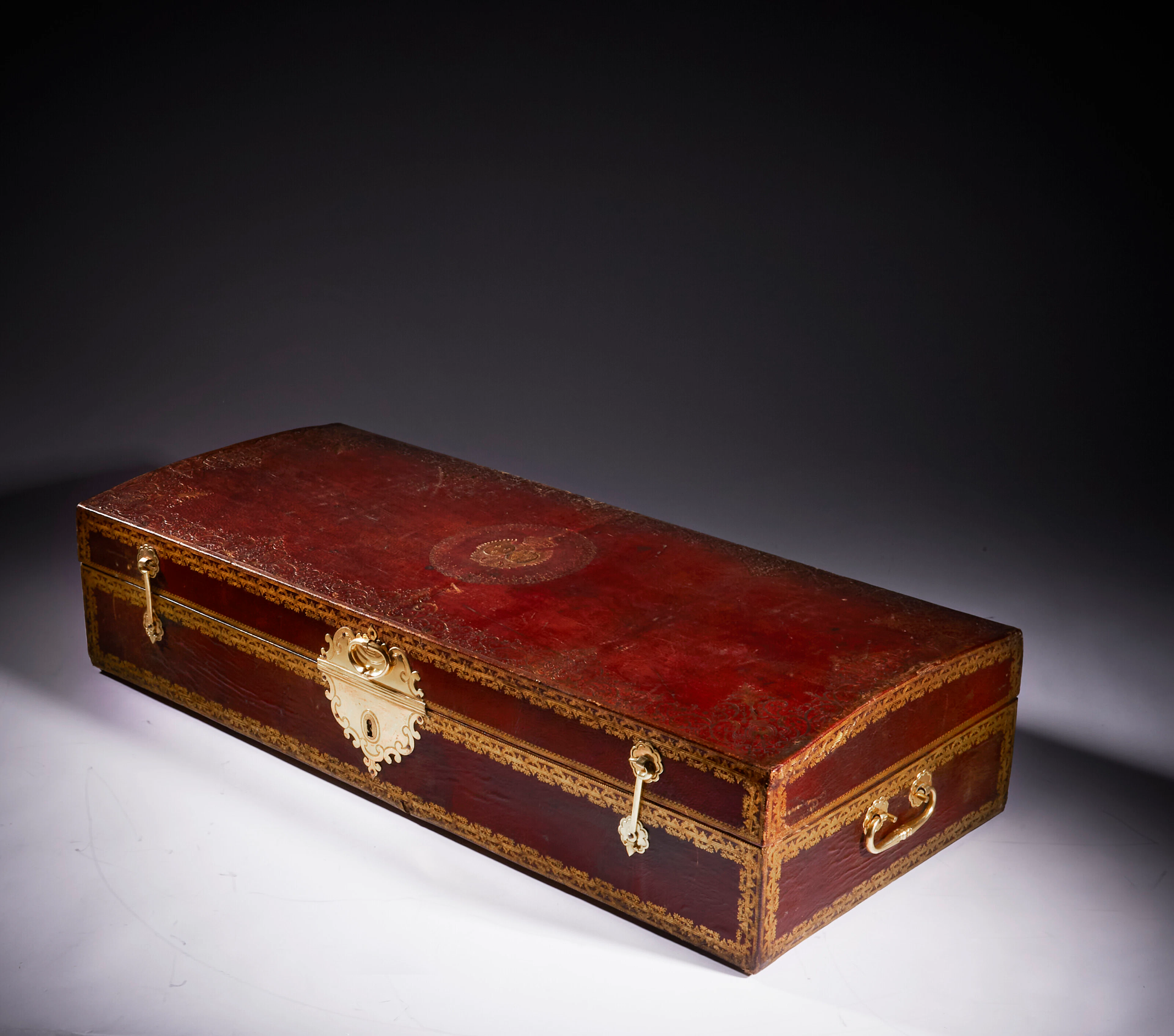 A ROYAL LOUIS XVI ORMOLU-MOUNTED GILT-TOOLED RED LEATHER COFFER