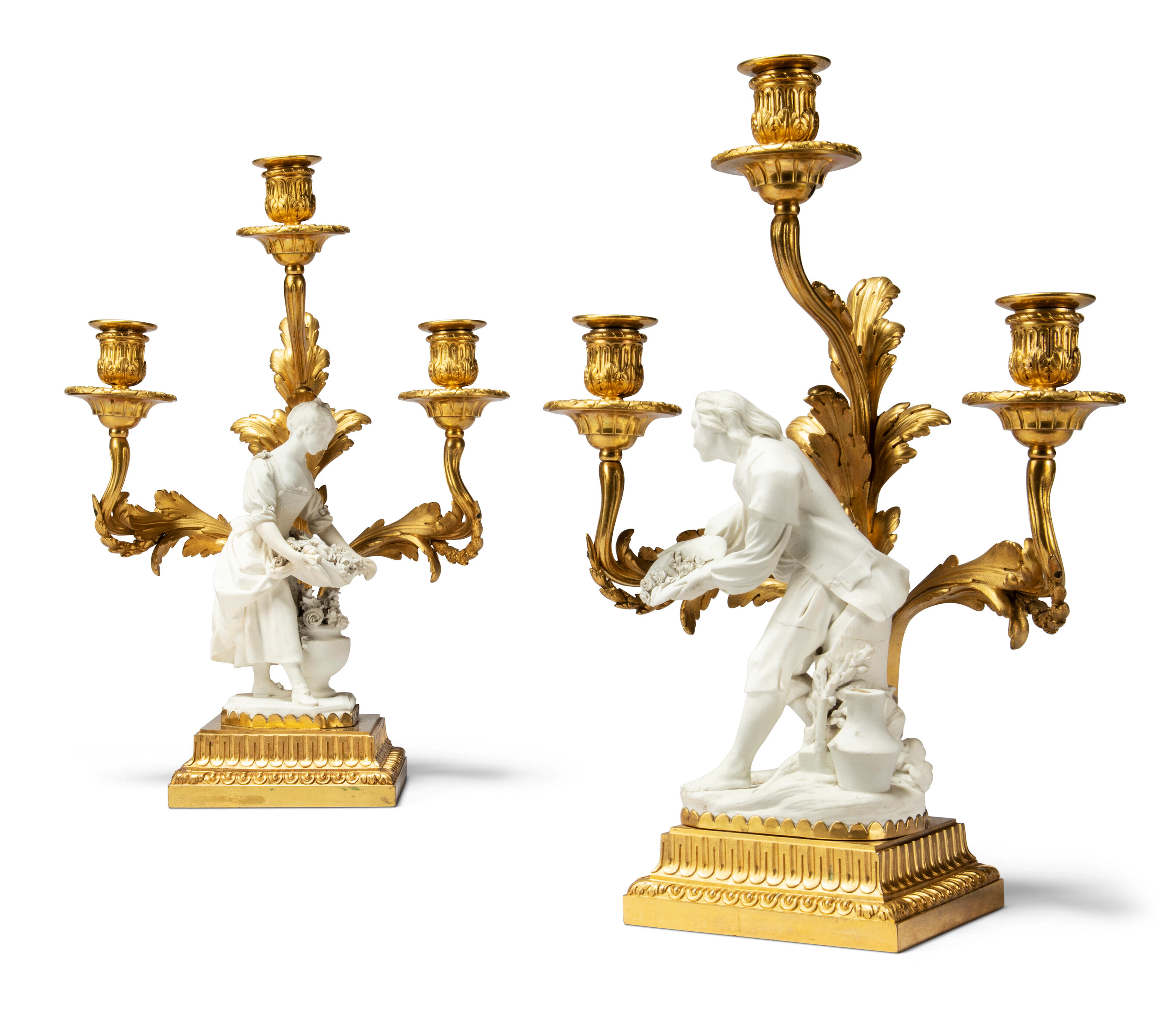 A PAIR OF FRENCH ORMOLU-MOUNTED BISCUIT PORCELAIN THREE-LIGHT CANDELABRA