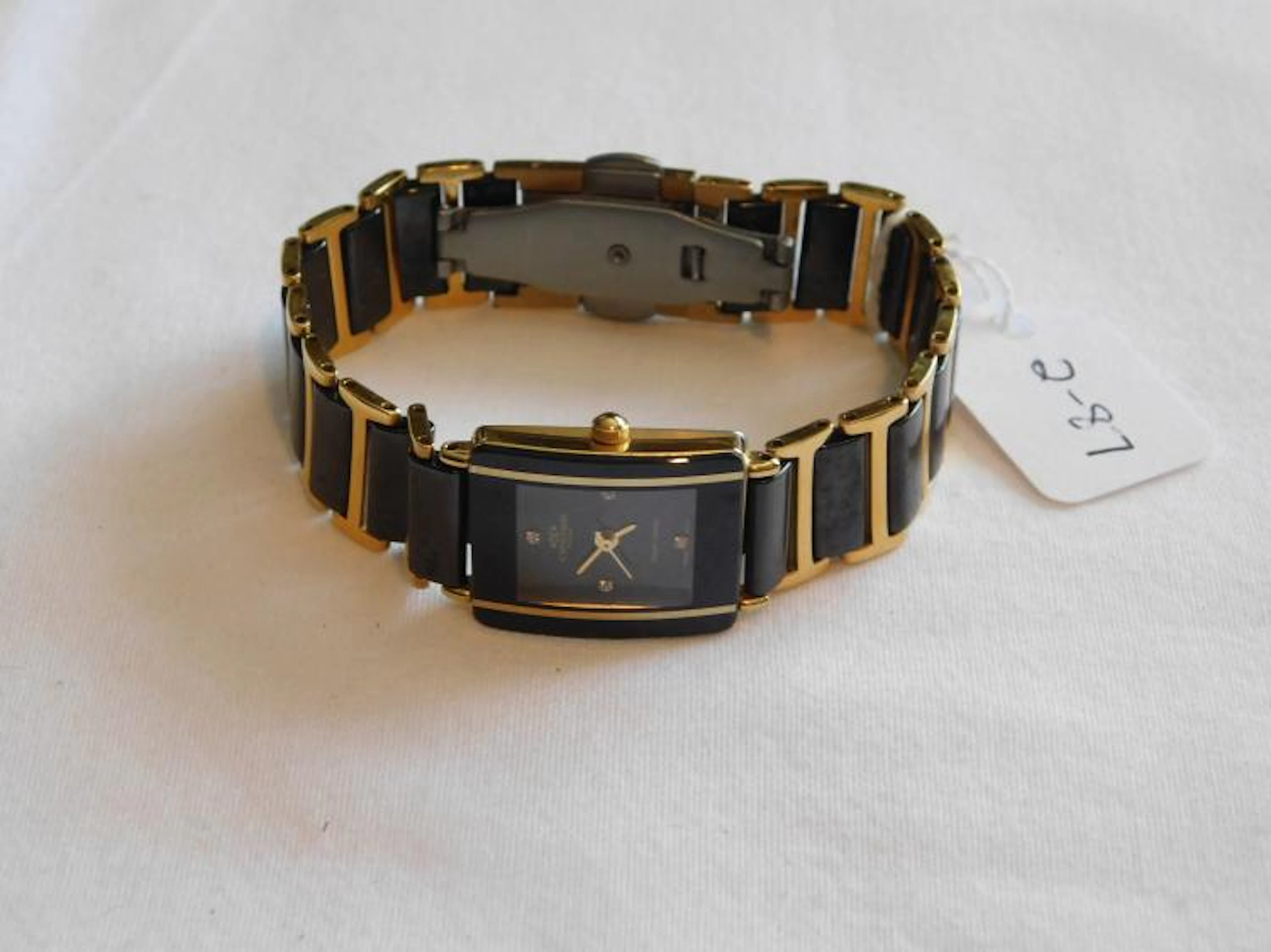 Oniss ladies watch with a gold plated and black enamel band and face