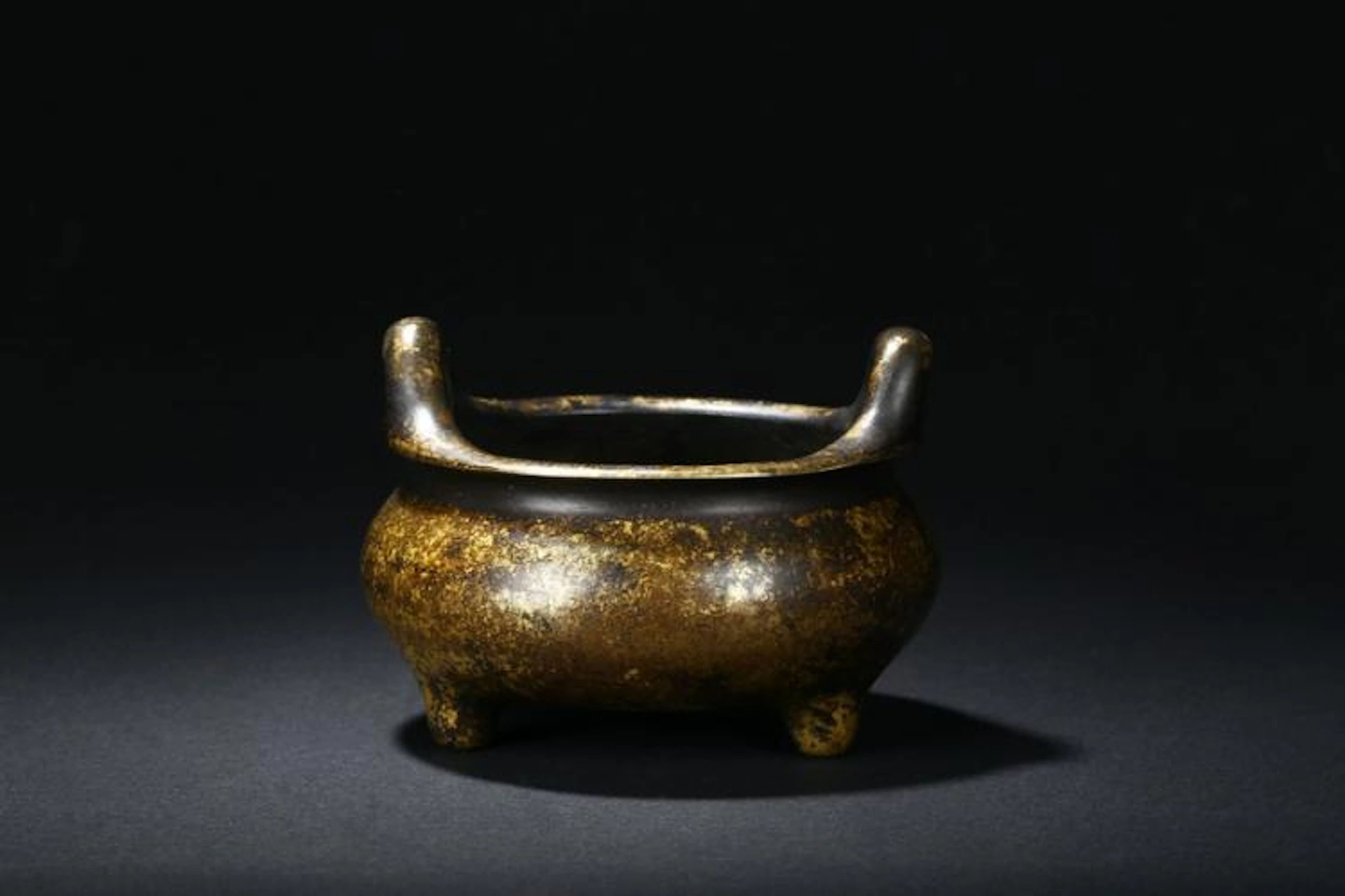 A BRONZE TRIPOD CENSER