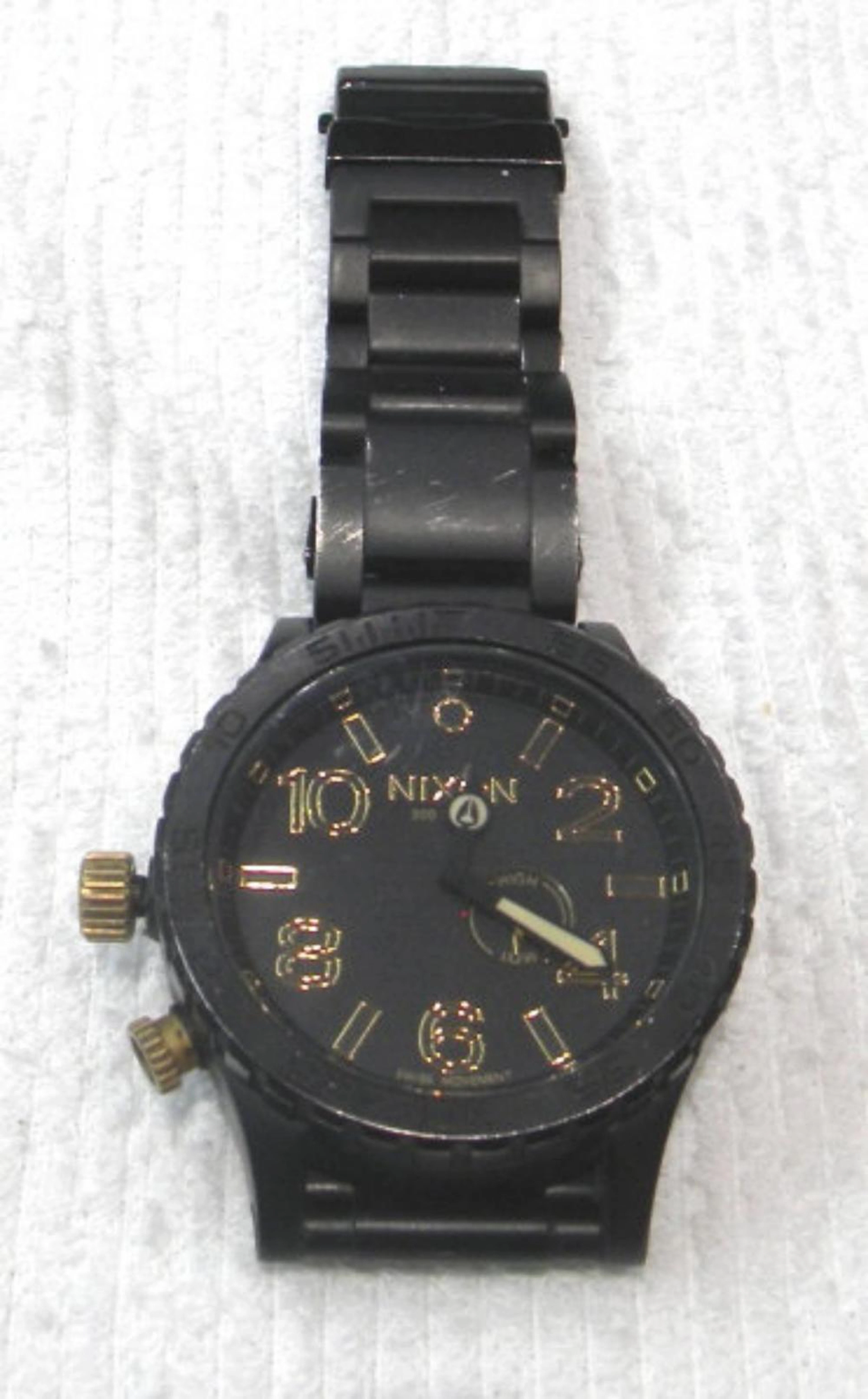Black Nixon Watch with Gold Accents