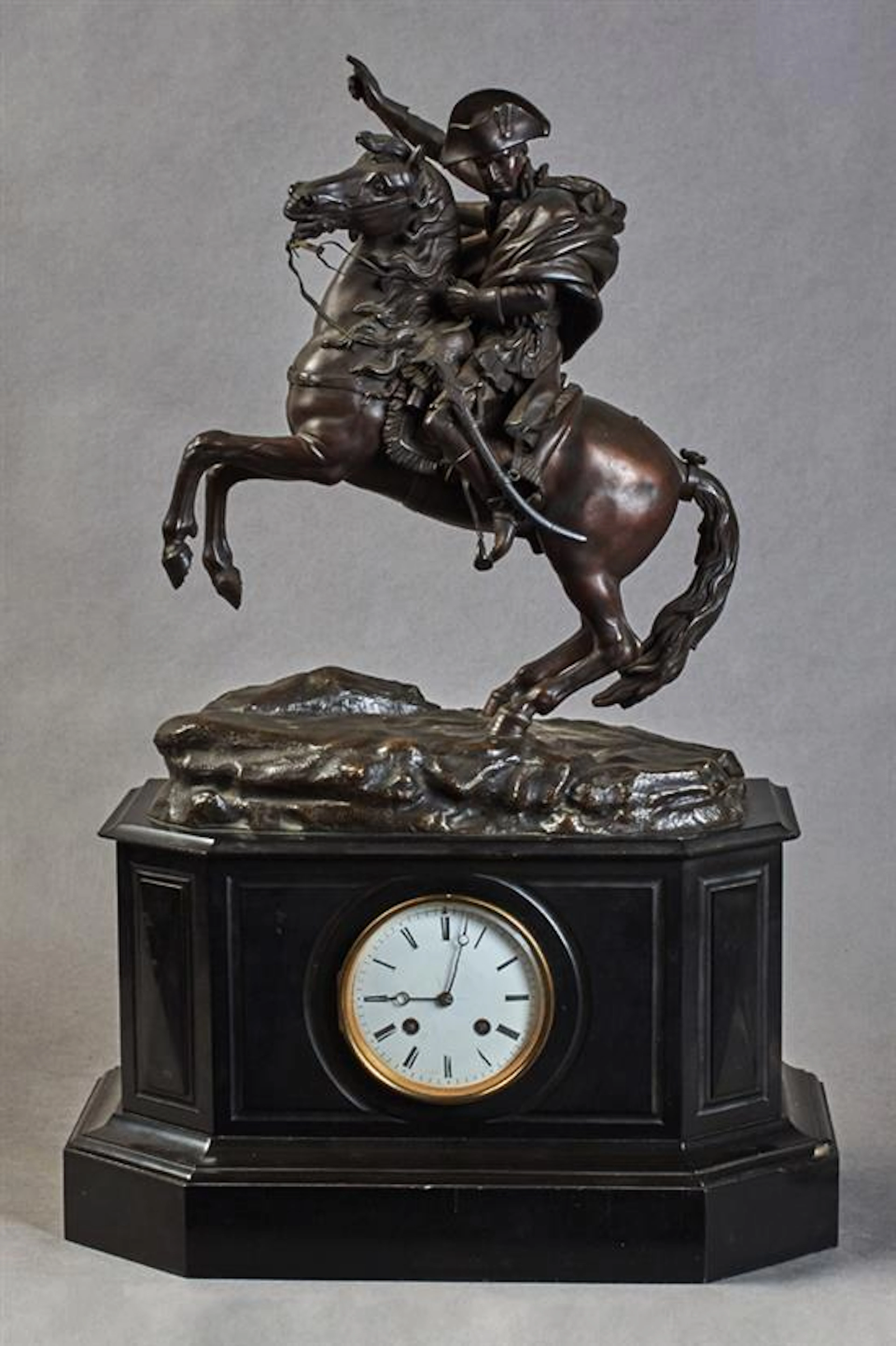 French Patinated Bronze and Black Marble Figural Mantle Clock, 19th c., by Samuel Marti, the top with a large bronze figure of "Napo...