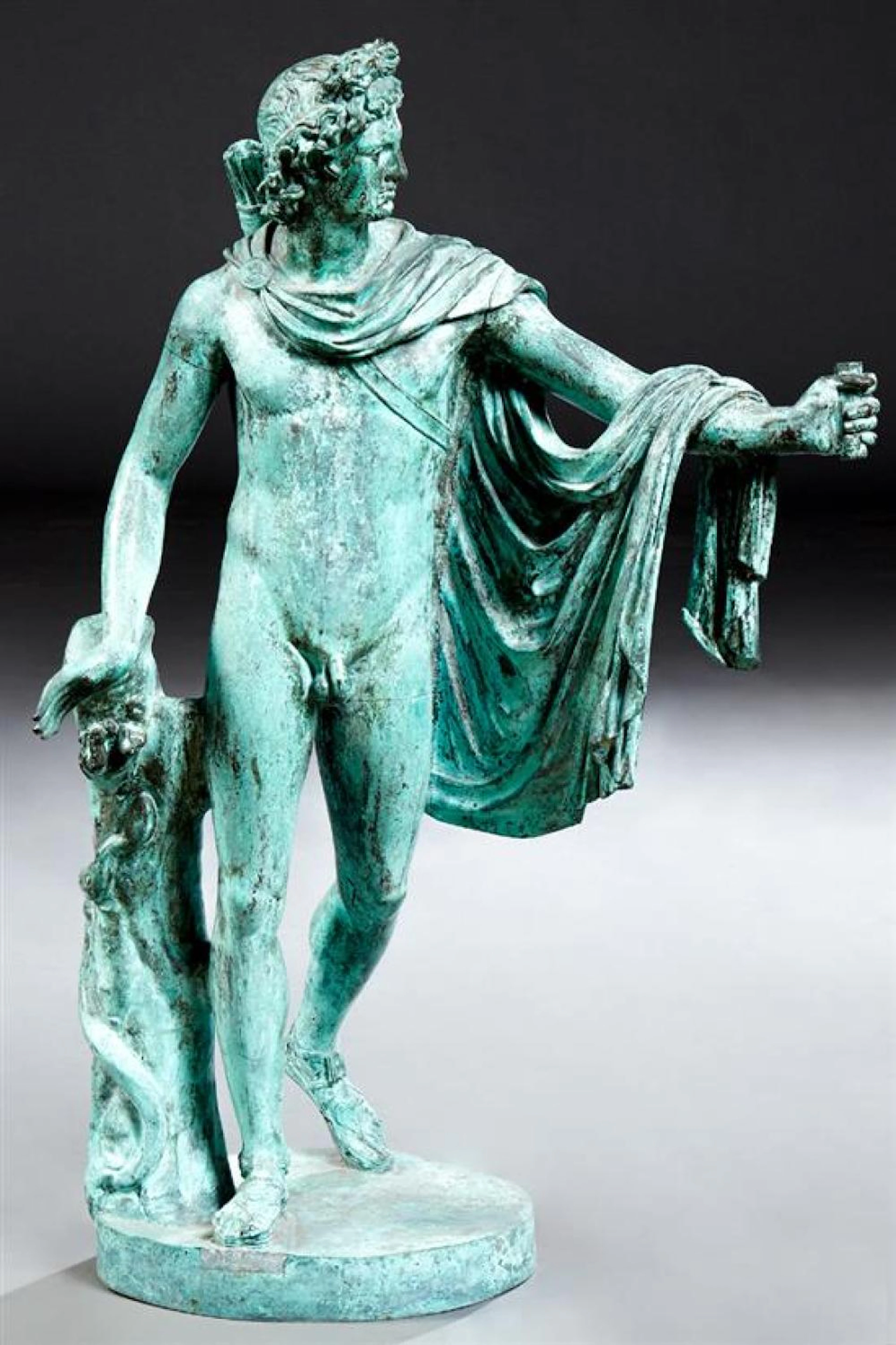 After Leochares, Classical Green Patinated Bronze Statue of Apollo the Archer, 20th c., after the antique, with a quiver and a robe...