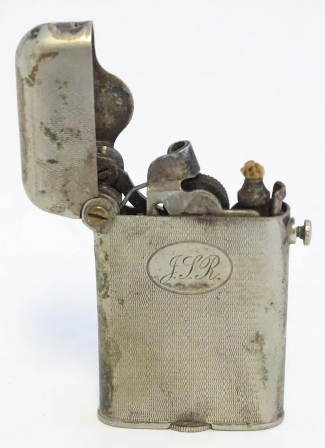 Collector's Cigarette Lighter: a silver plate Thorens mechanical push button lighter patented January 28 1922.