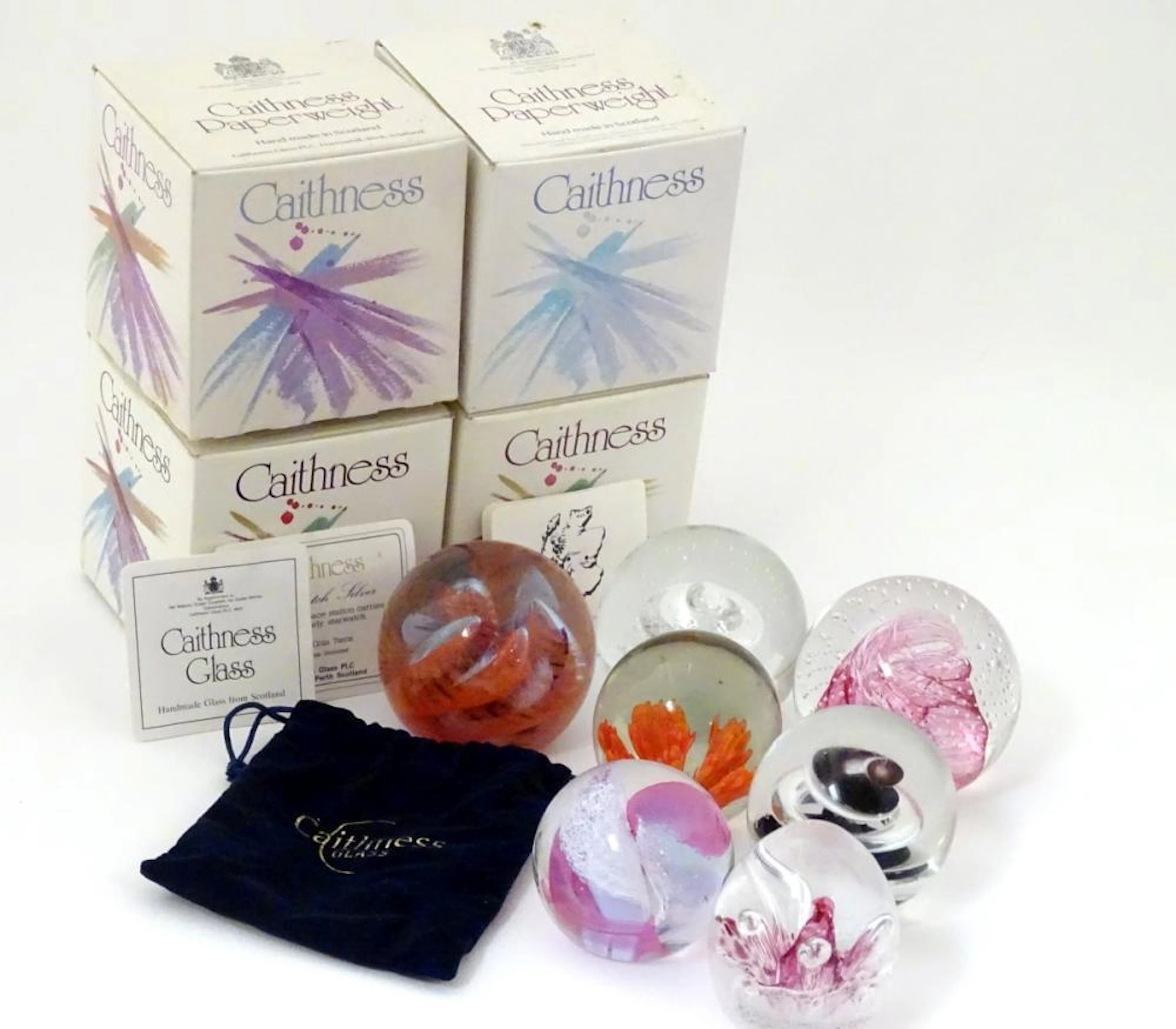 A collection of Caithness studio glass paperweight…