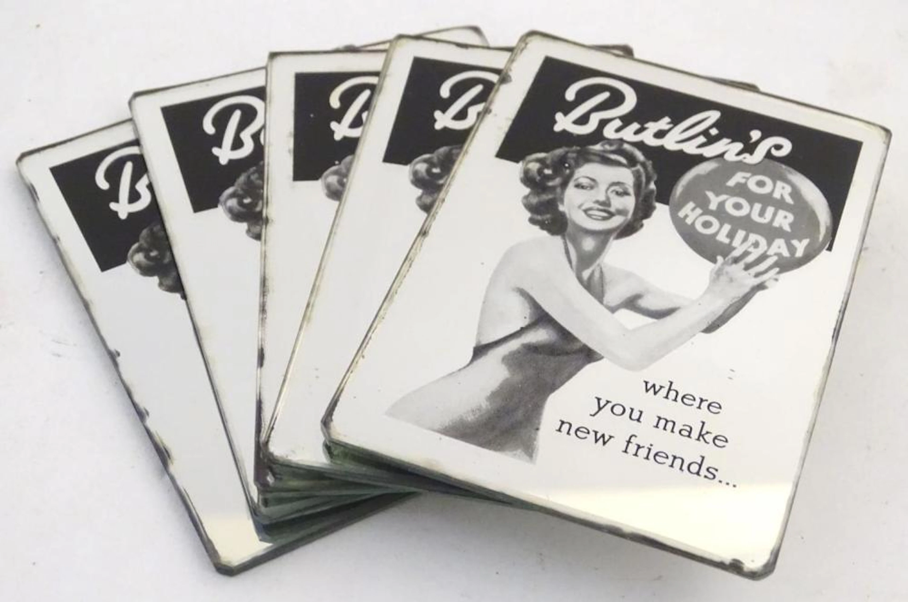 Five small 20thC advertising mirrors for Butlin's holidays. Approx. 3 1/2" x 2 1/2" (5)