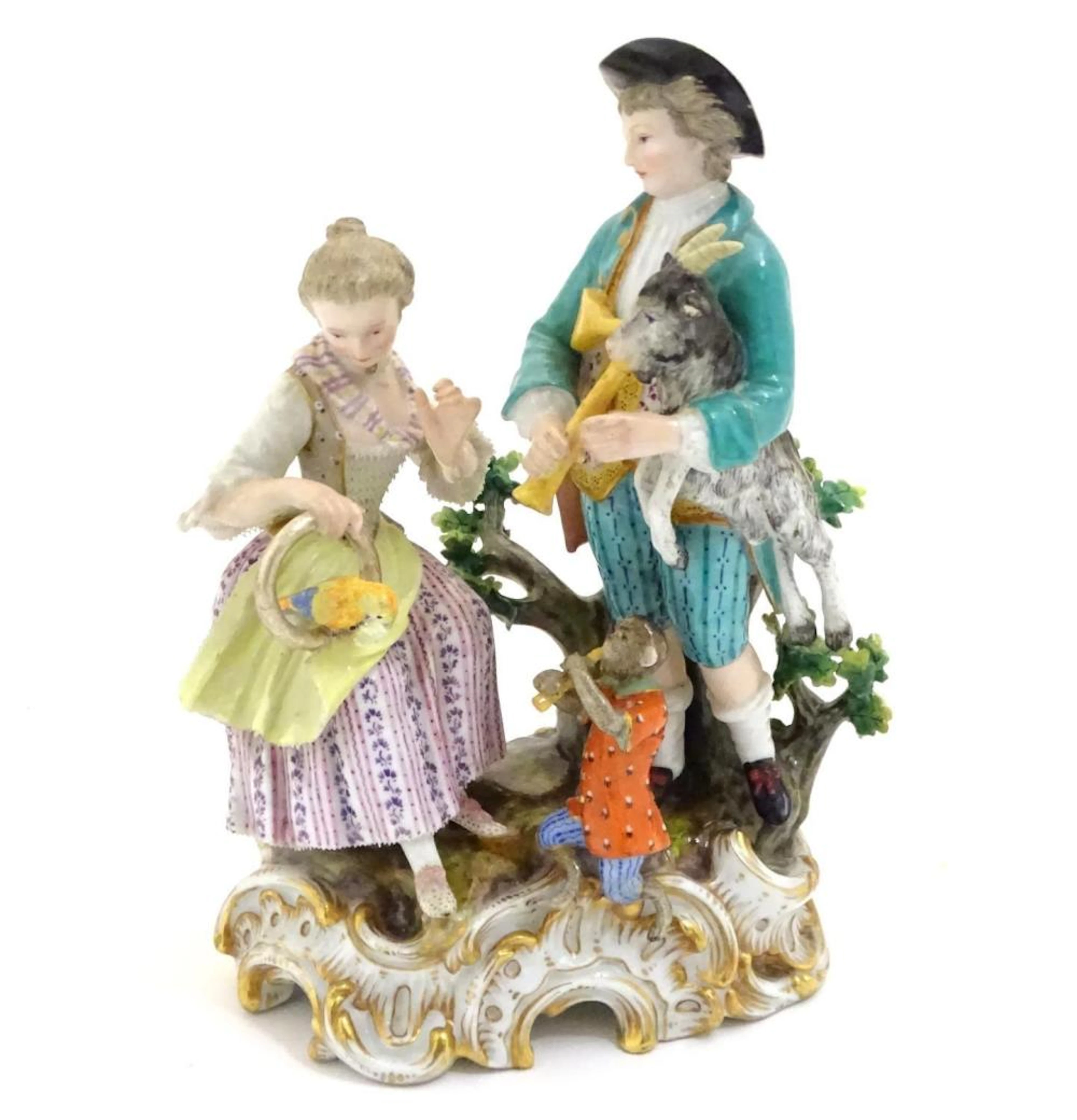 A Continental porcelain figural group on a natural…