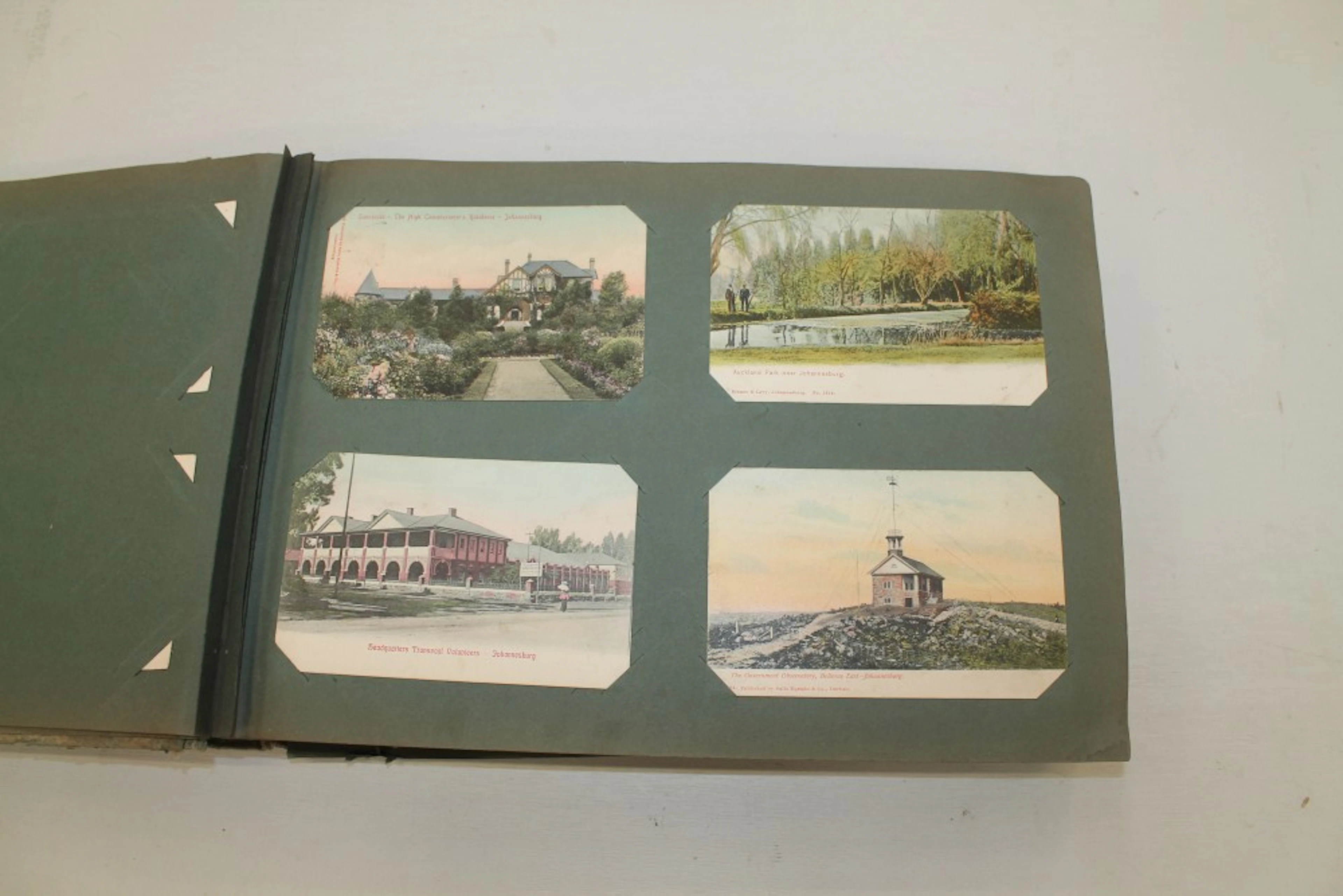 Postcards in album - selection of early 1900s South African cards - including
