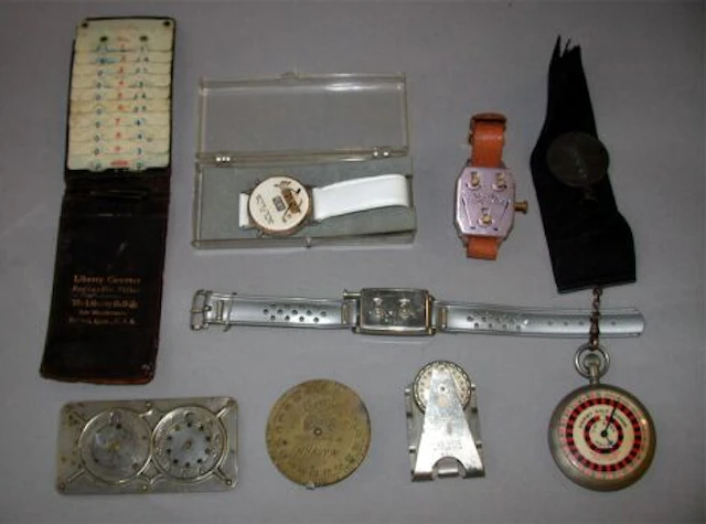 A Dormie ""watch"" golf scorer; a ""handy"" brass dial golf scorer; an M