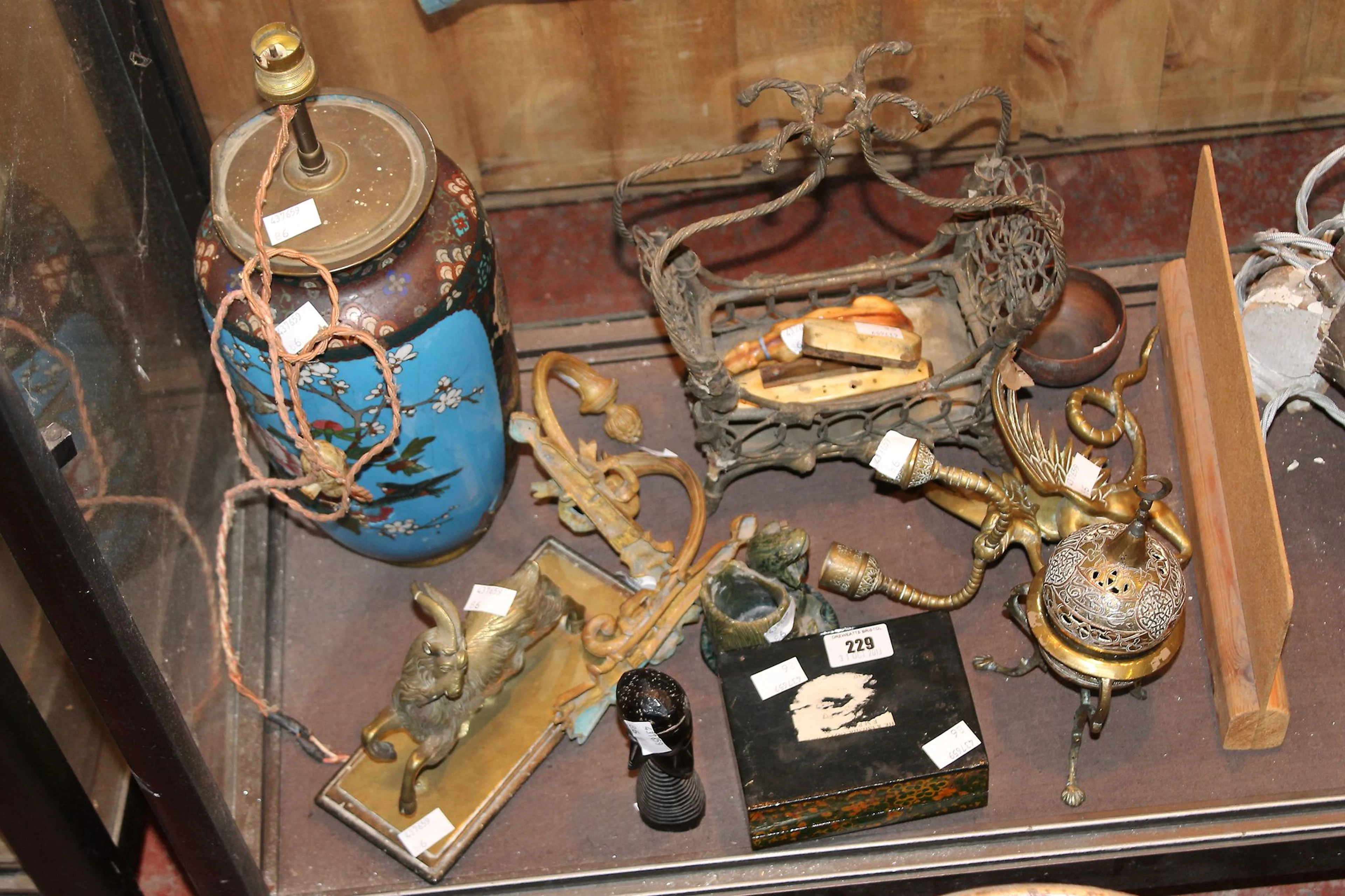 An Islamic brass overlaid copper and silver censer set on tripod feet