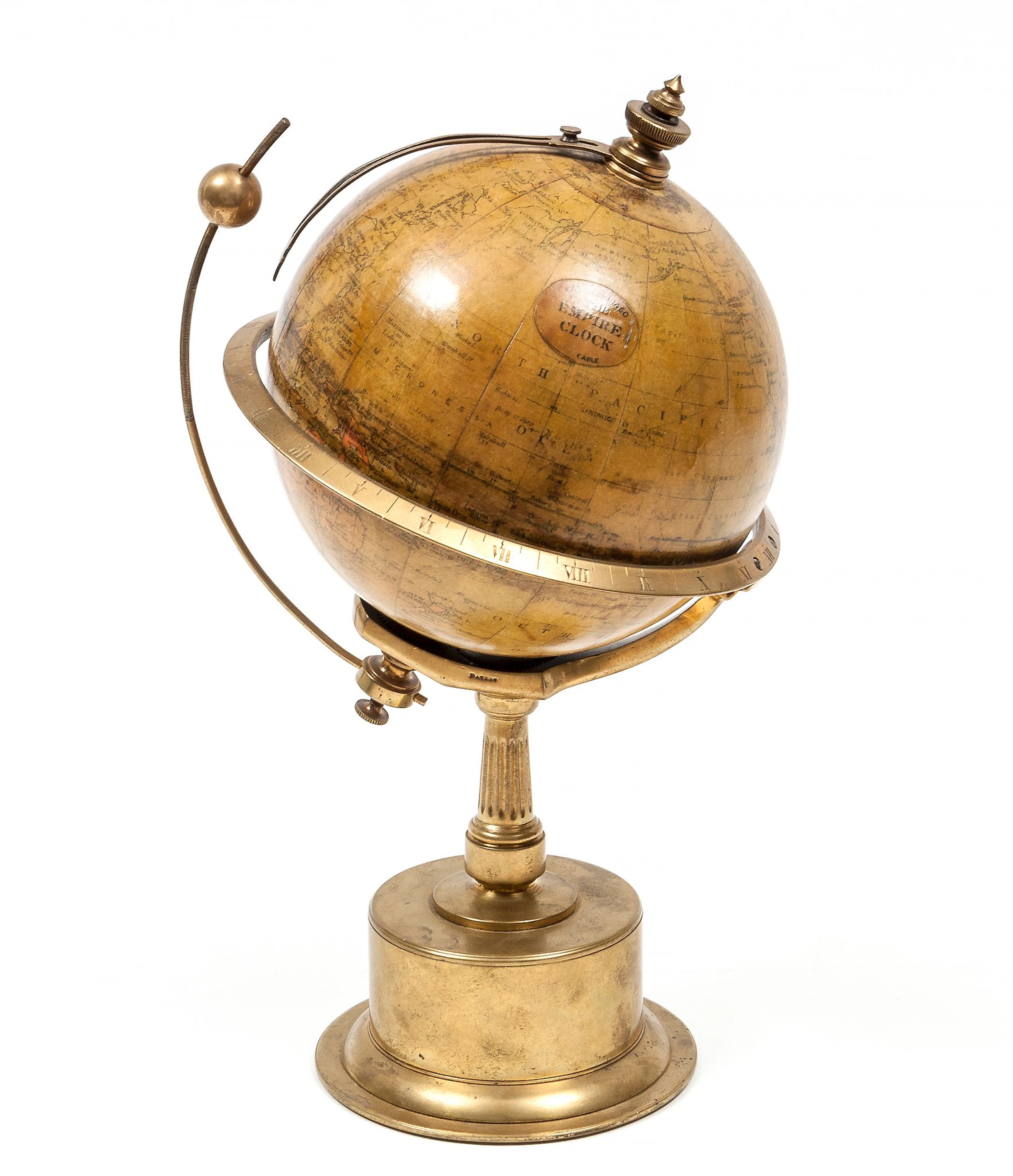 A brass patent "Empire Clock" globe timepiece