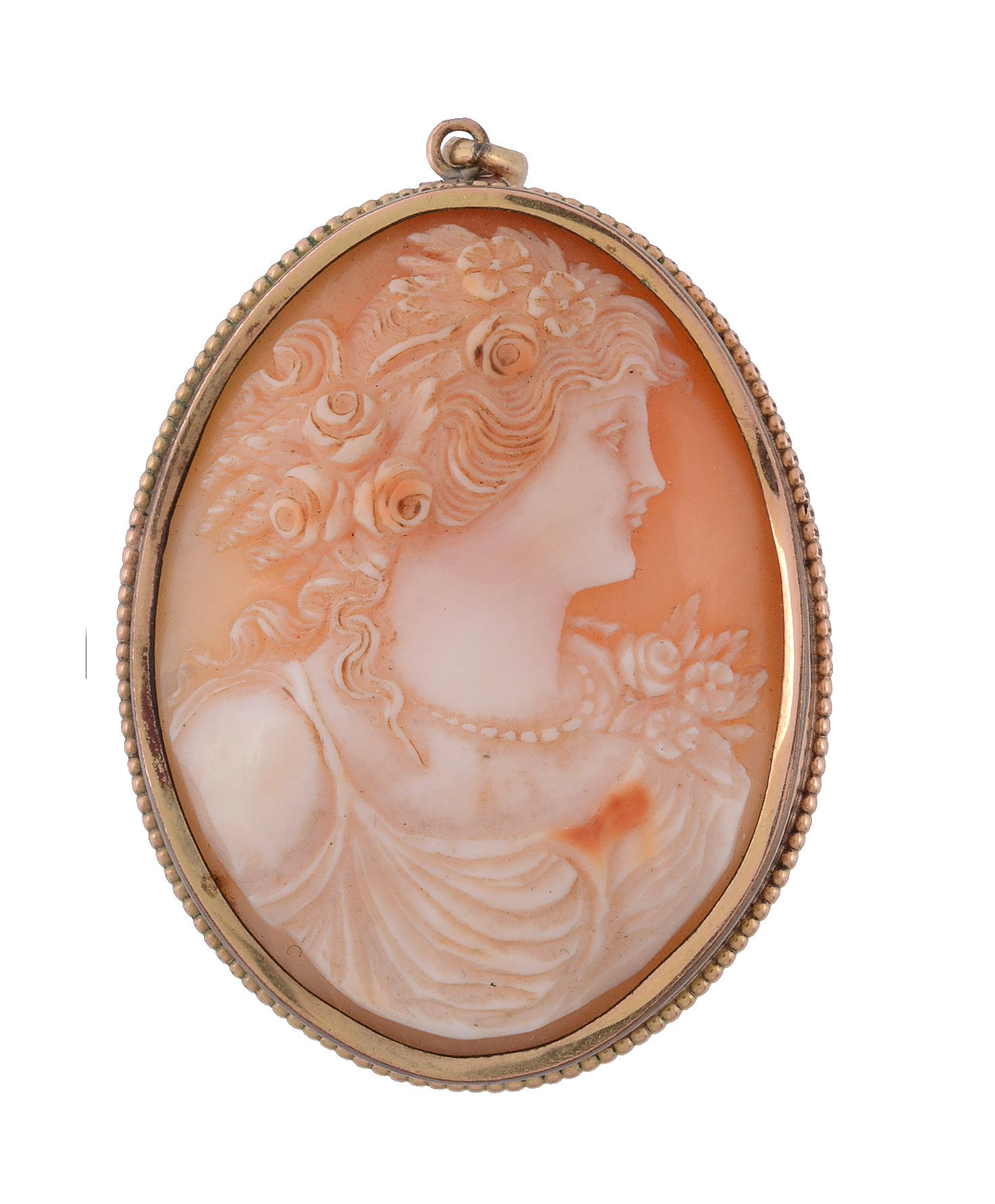 A shell cameo brooch ,circa 1900, the oval shell carved with the profile of...