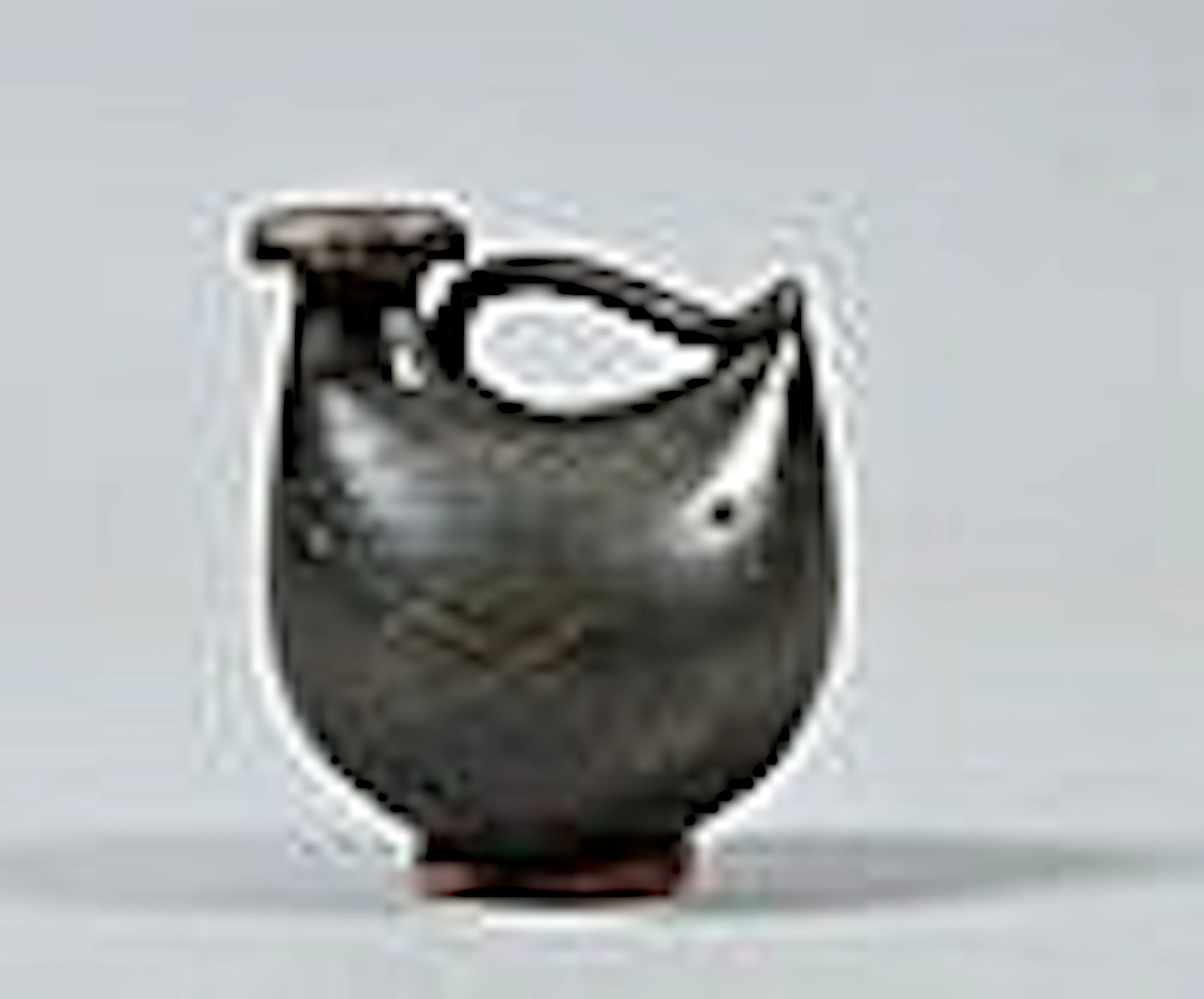 An Etruscan two handled pottery cup, brown glazed
