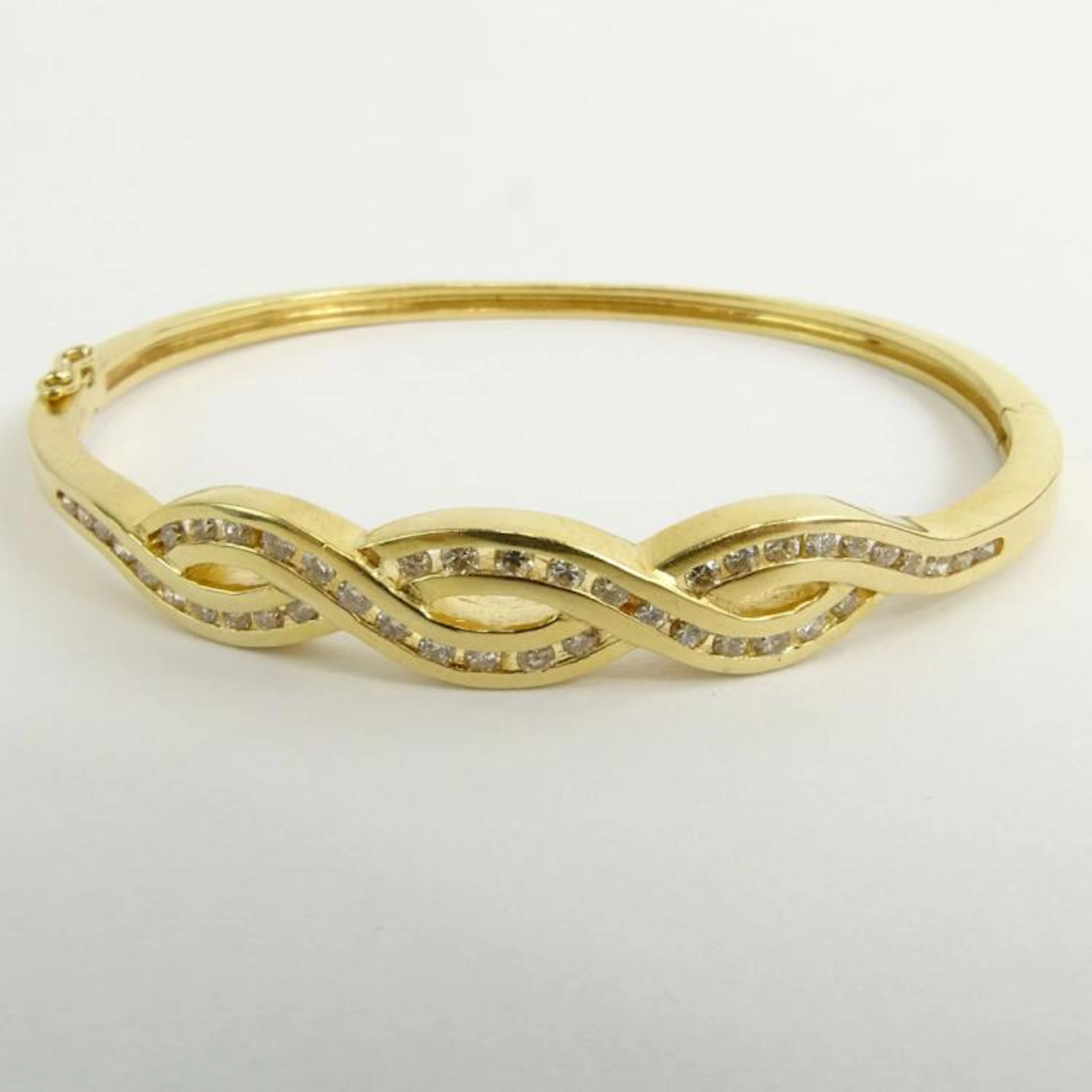 Vintage 14 Karat Yellow Gold and Round Cut Diamond Bangle Bracelet. Signed 14K 585. Good vintage condition. Measures 2-1/8" interior diam., 1/4" W. Approx. weight: 9.70 pennyweights