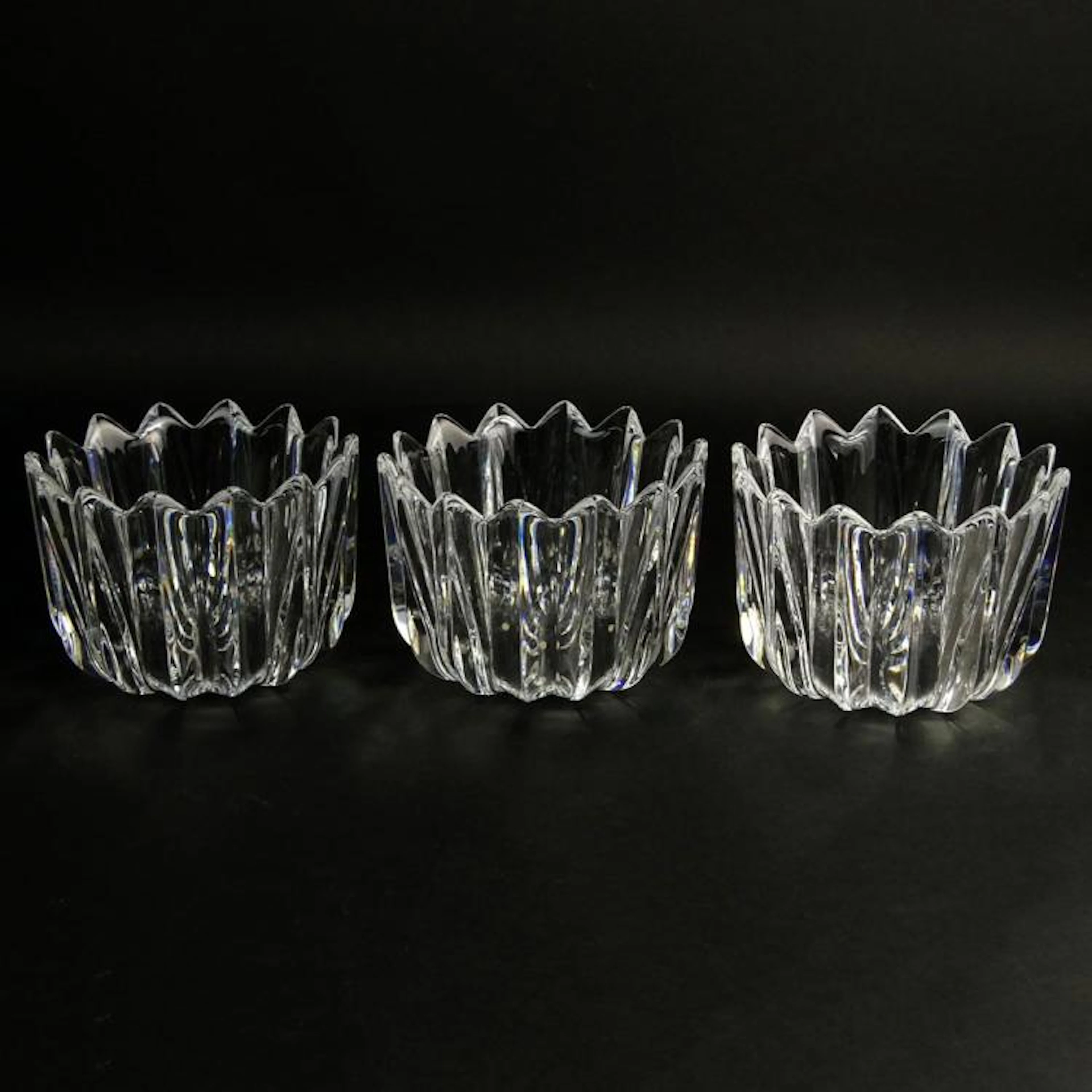 Set of Three (3) Orrefors Ribbed Crystal Vases. Signed on bottom. Display scratches on bottom or in good condition. Measures 4-1/4" H x 6" dia.
