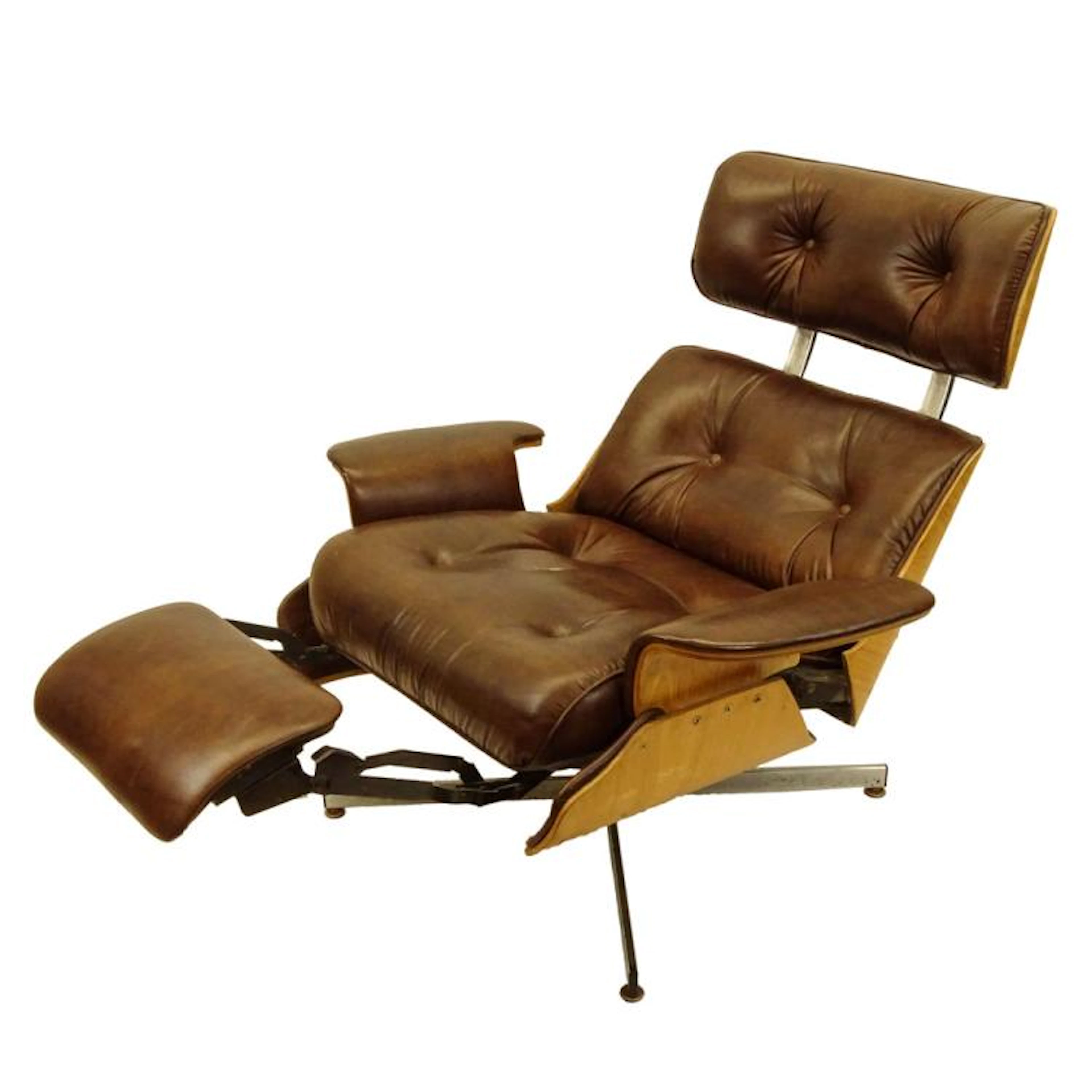 Mid Century Modern Plycraft Eames Style Recliner With Built-in Footrest. Unsigned. Split to seat, wear and soiling from use and age. Measures 37-1/2" x 35" x 22"