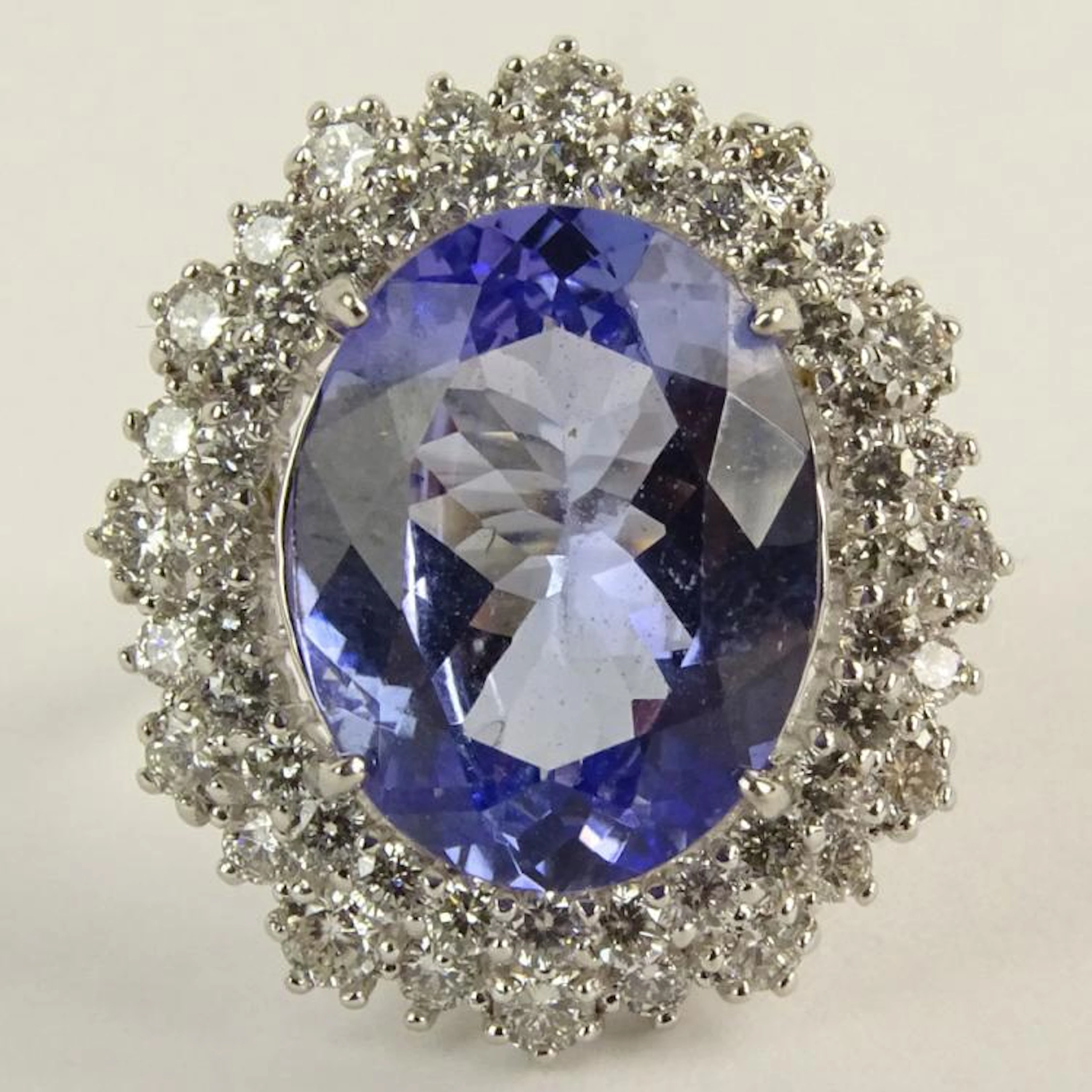Lady's Oval Cut Tanzanite, Round Brilliant Cut Diamond and 18 Karat White Gold Ring. Tanzanite measures 15mm x 12mm. Diamonds F-G color, VS-SI clarity. Signed 18K. Very good condition. Ring size 6-1/2