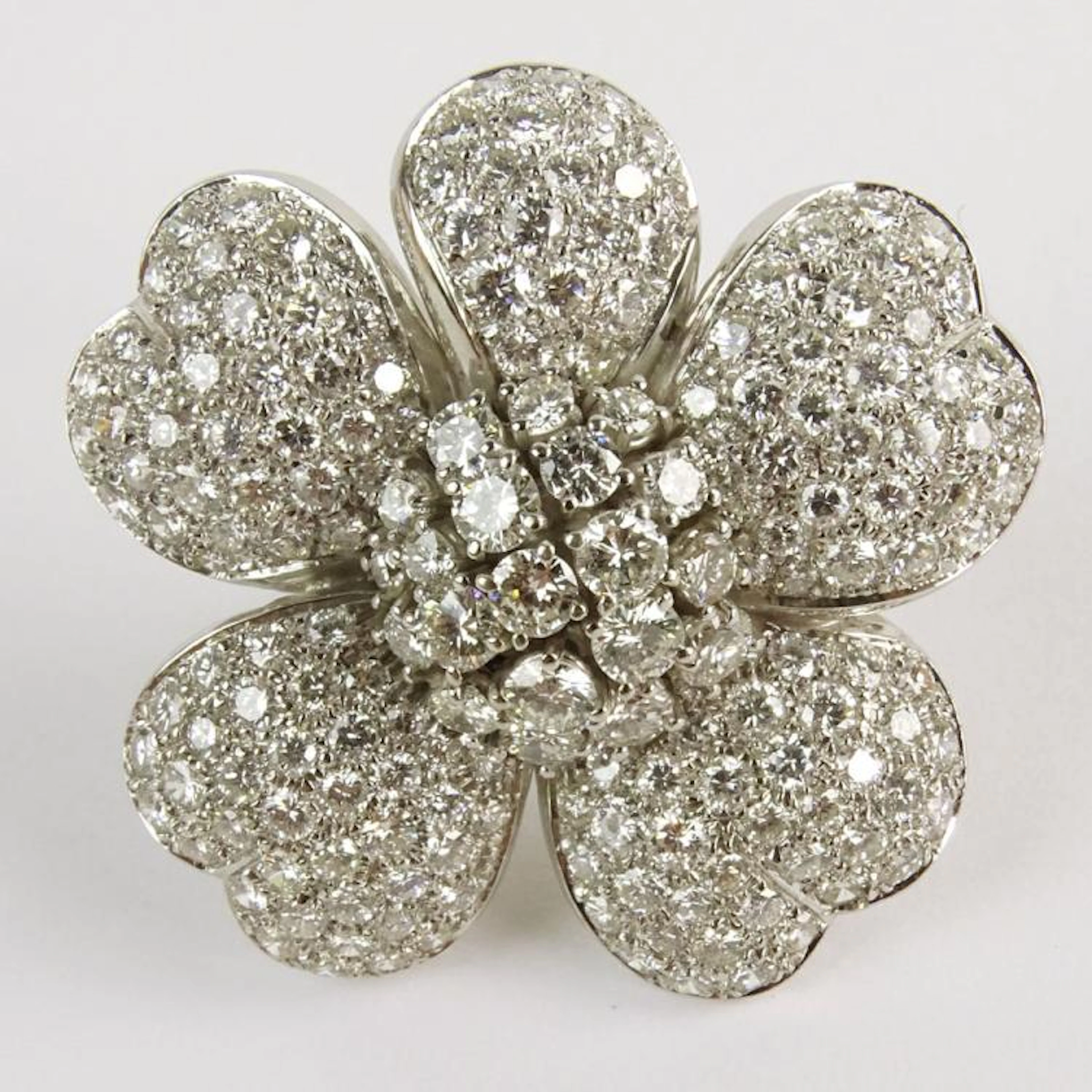 Lady's Approx. 12.0 Carat Round Brilliant Cut Diamond and 18 Karat White Gold Flower Ring. Diamonds E-F-G color, VS clarity. Signed 18K. Very good condition. Ring size 6-1/2. Approx. weight: 17.50 pen