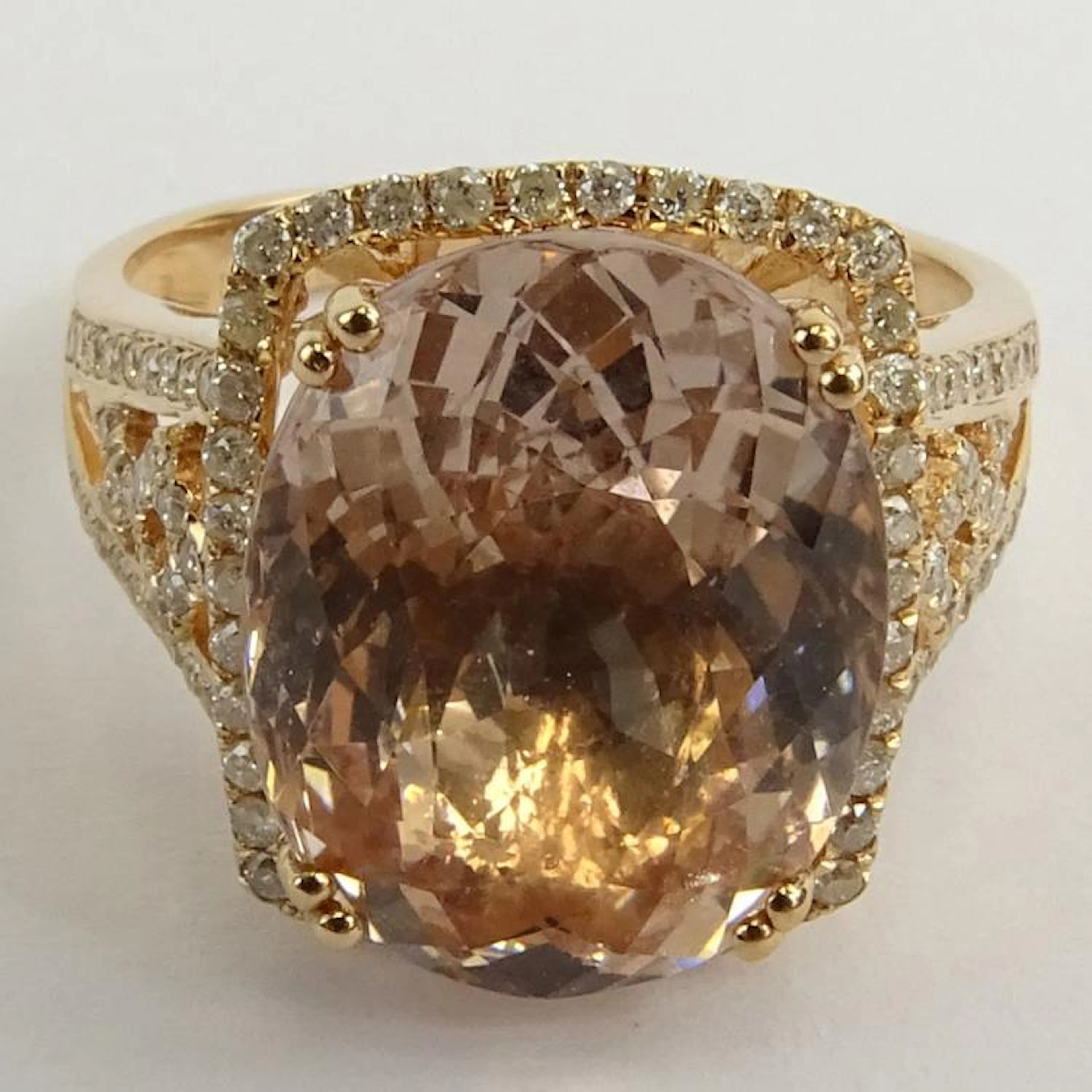 AIG Certified 7.60 Carat Oval Cut Morganite and 14 Karat Rose Gold Ring Accented with .42 Carat Round Brilliant Cut Diamonds. Diamonds H-J color, I1-I2 clarity. Signed 14K. Very good condition. Ring s