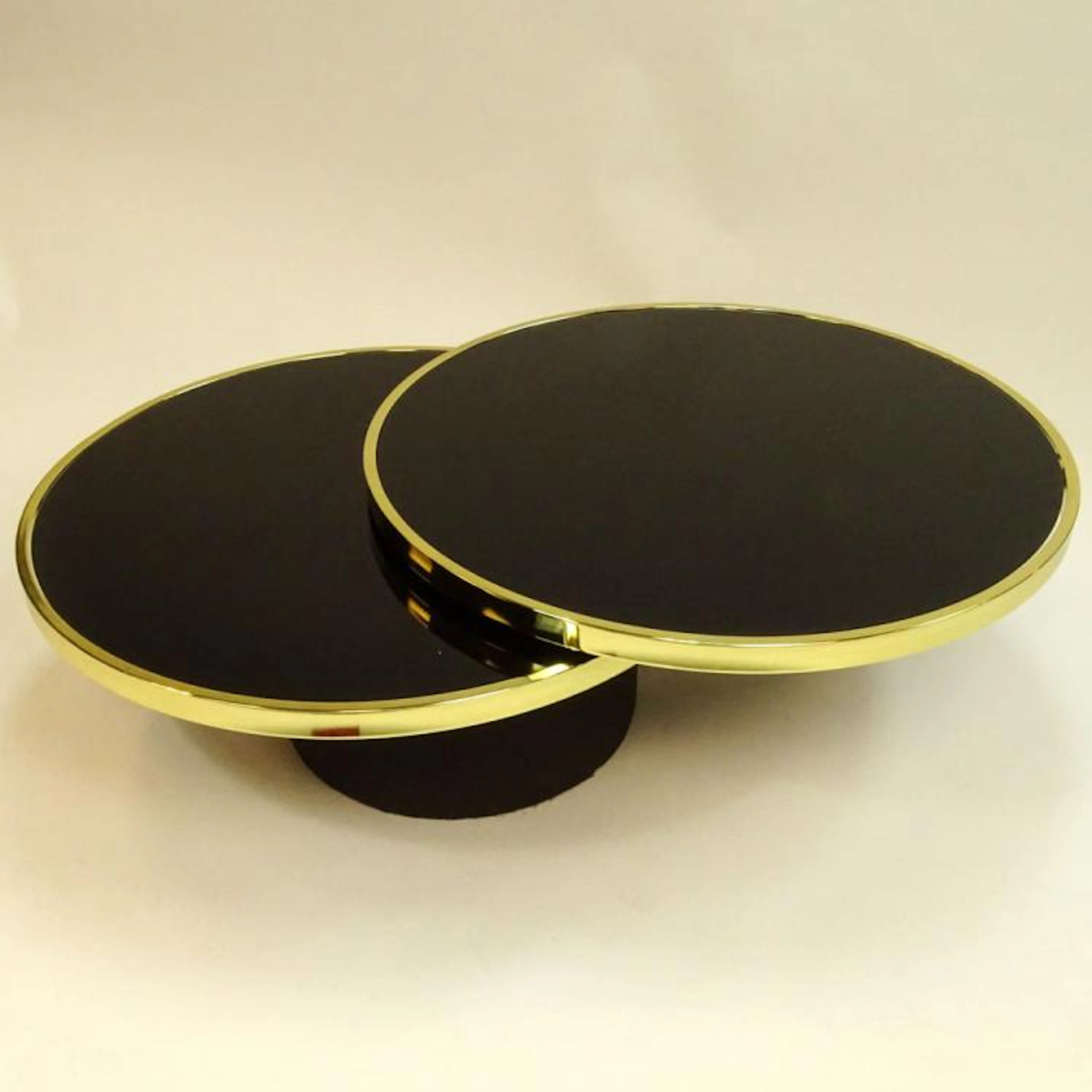 Design Institue America DIA Black Glass and Brass Swivel Coffee Table. Unsigned. Light surface scratches or in good condition. Measures 14-1/2" H x 36-1/4" dia (closed)